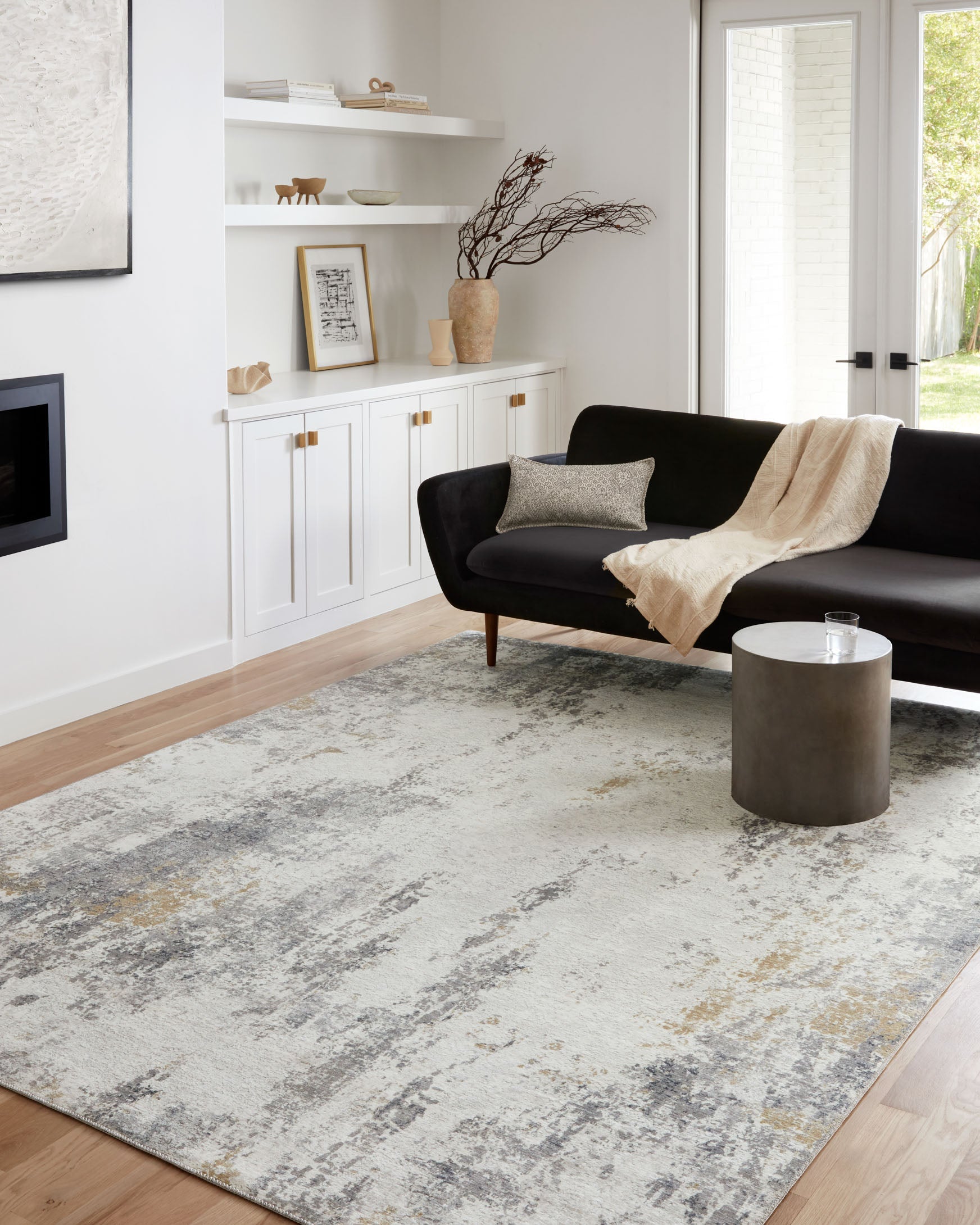 Ivory and gray abstract area rug under living room furniture, distressed texture.