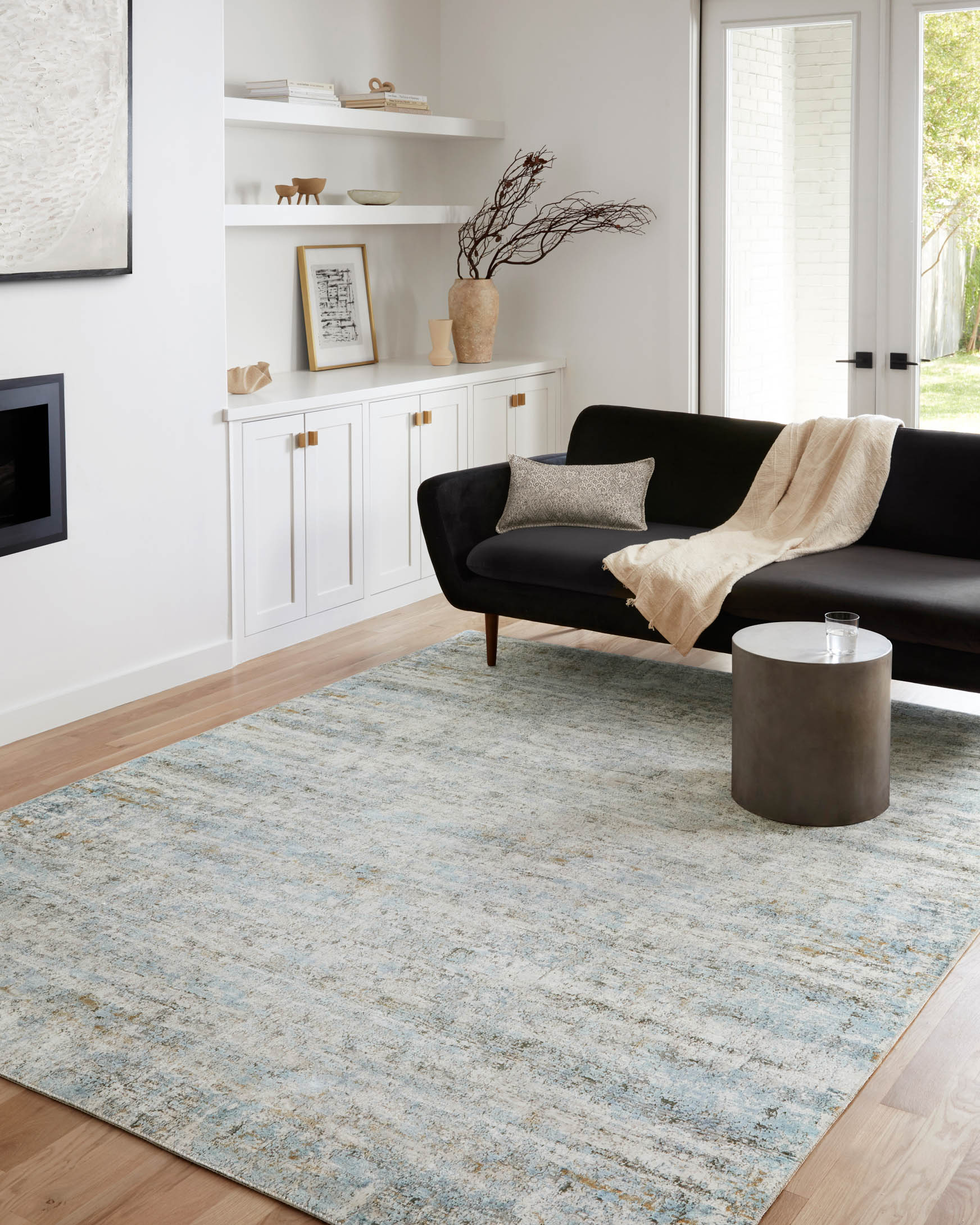Ivory and sky blue power-loomed rug with distressed abstract pattern, corner view