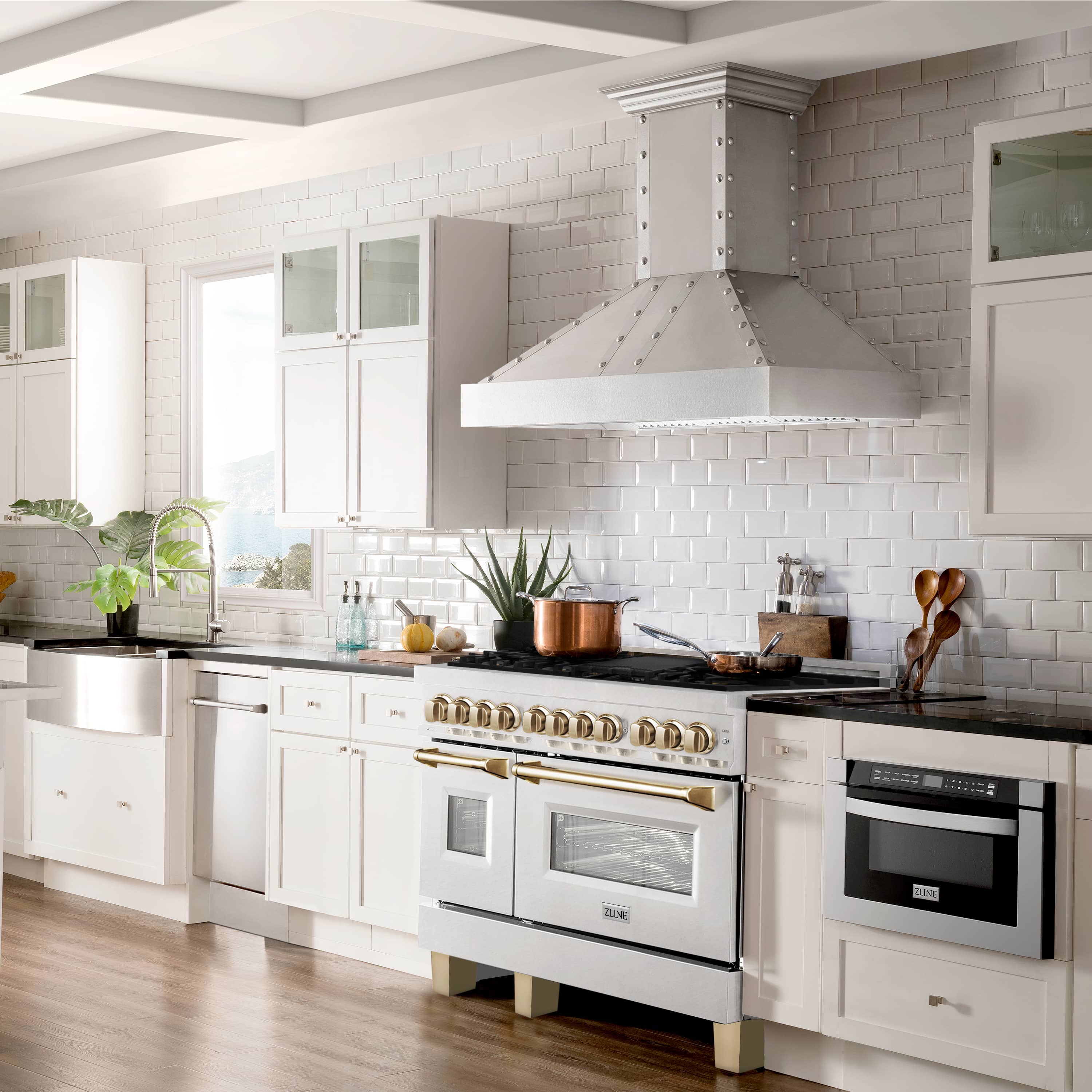 Fingerprint-resistant stainless range with gold accents and multiple oven doors