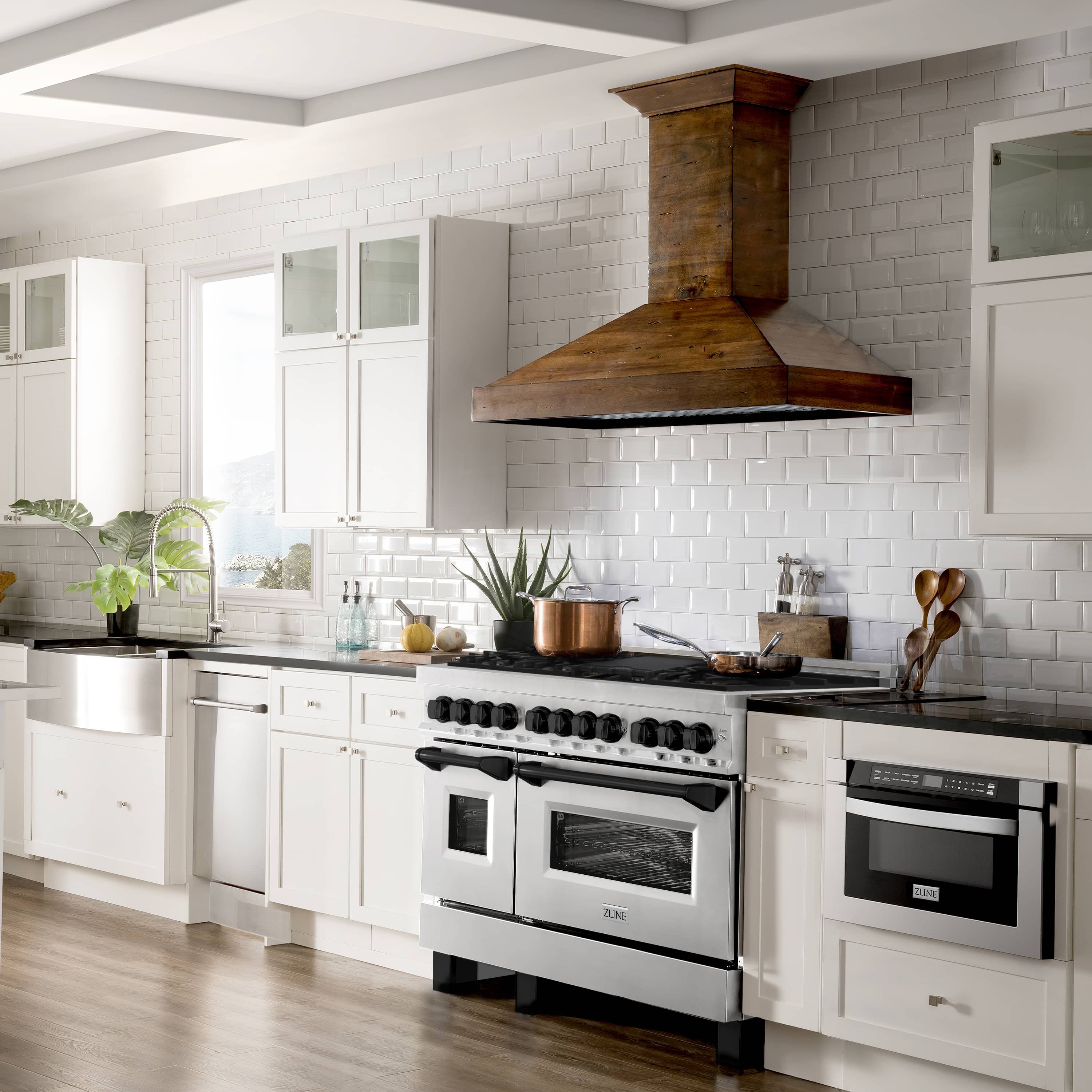Stainless steel dual fuel range with matte black accents, grates, and double oven doors