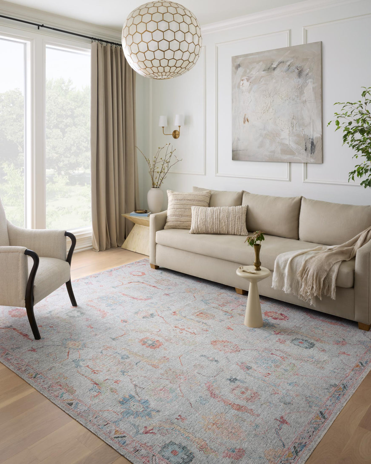 Colorful traditional area rug with distressed motif, styled under a lamp in a living room