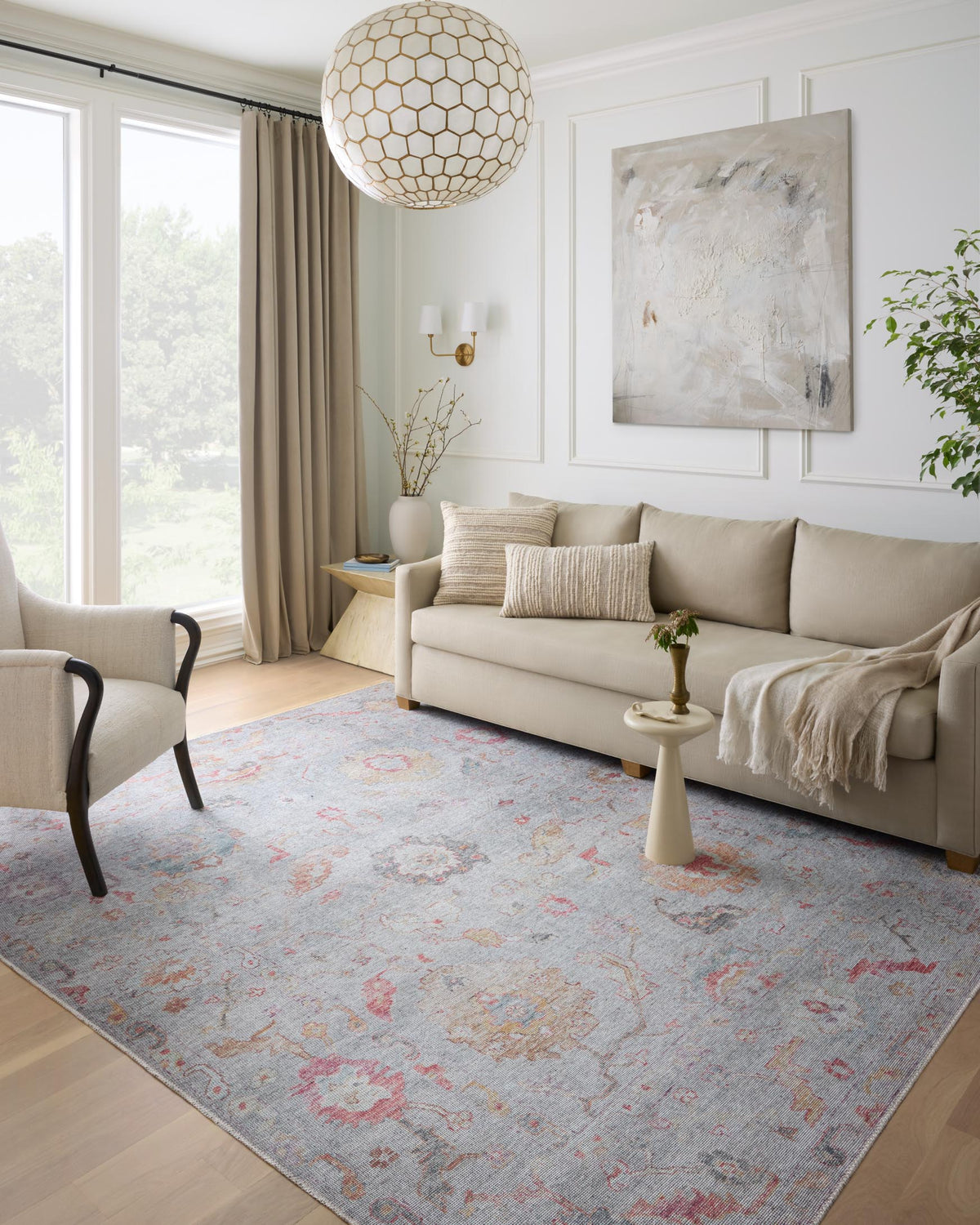 Traditional area rug in light silver with pink, orange, and blue distressed motif