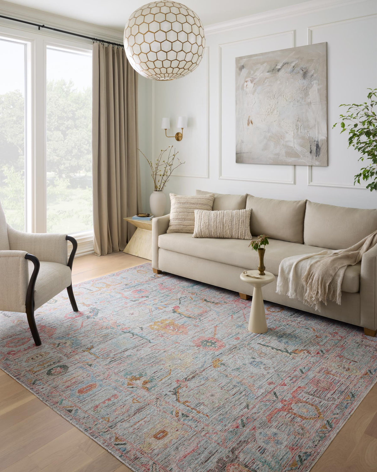 Traditional area rug in a living room, multi-color geometric pattern on wood floor