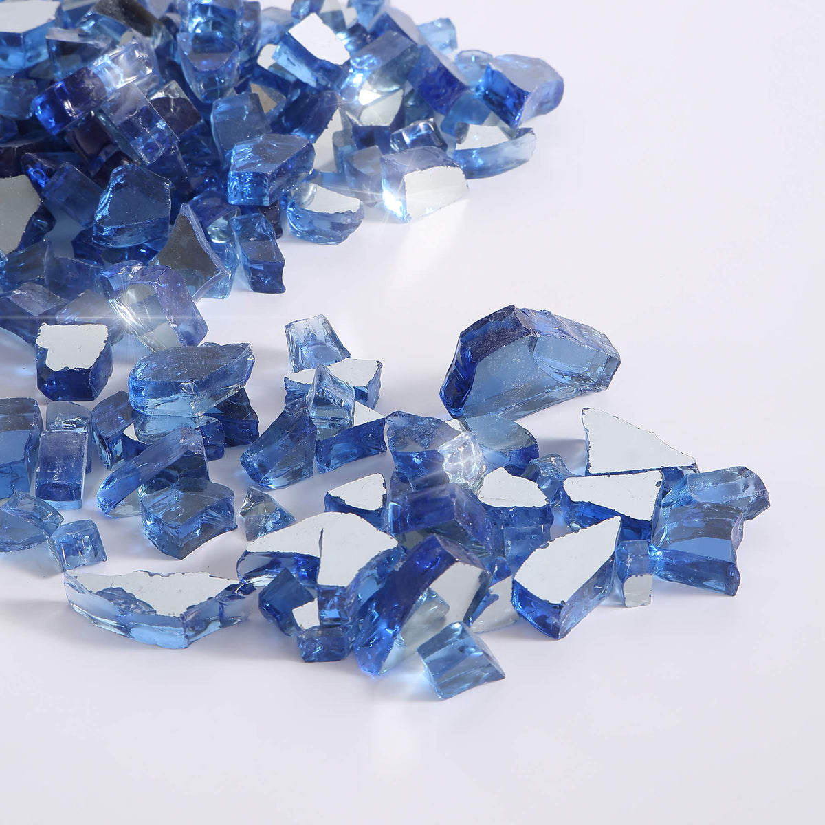 Close-up of midnight blue reflective fire glass chunks, glossy and faceted