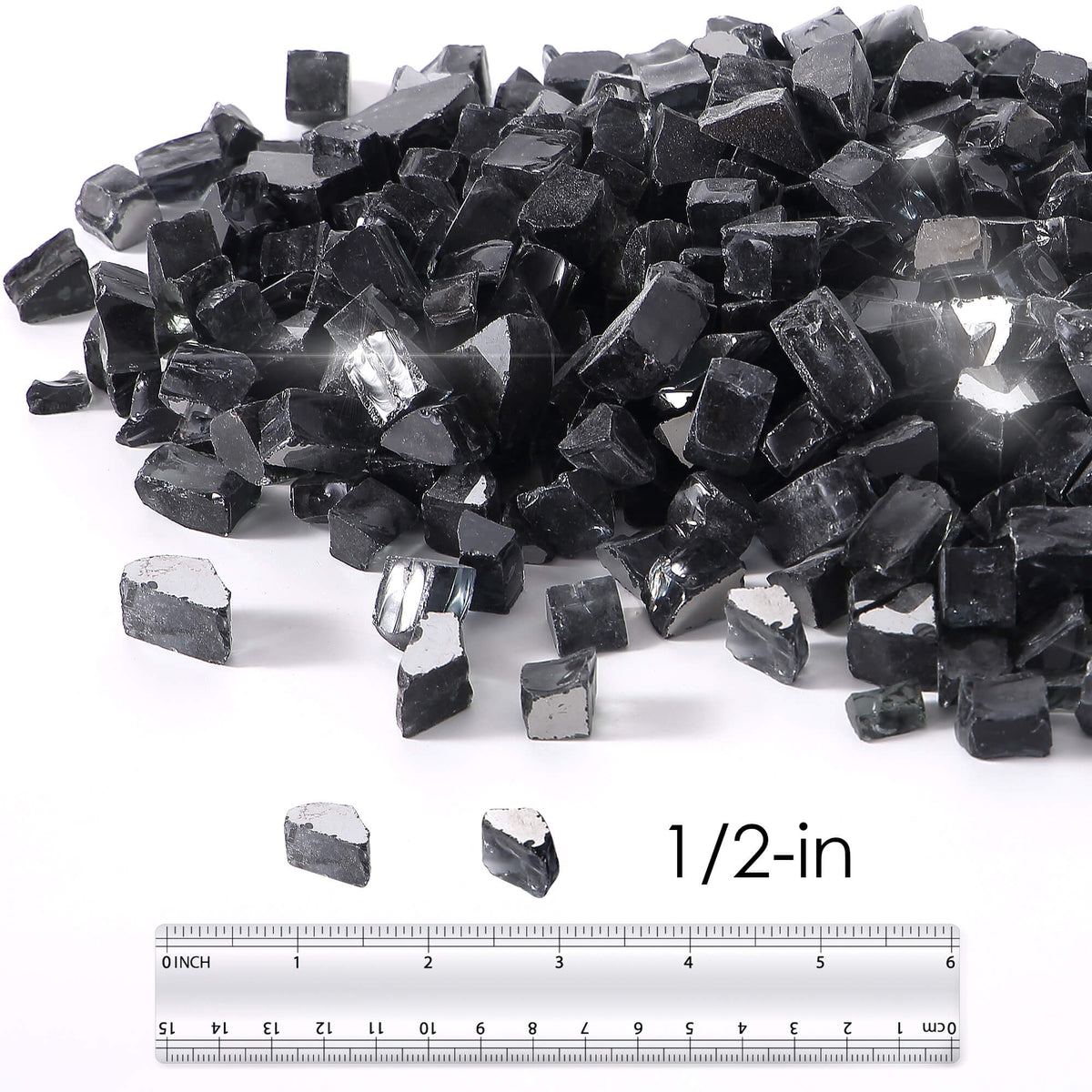 Black reflective tempered fire glass pieces beside ruler marked 1/2-in