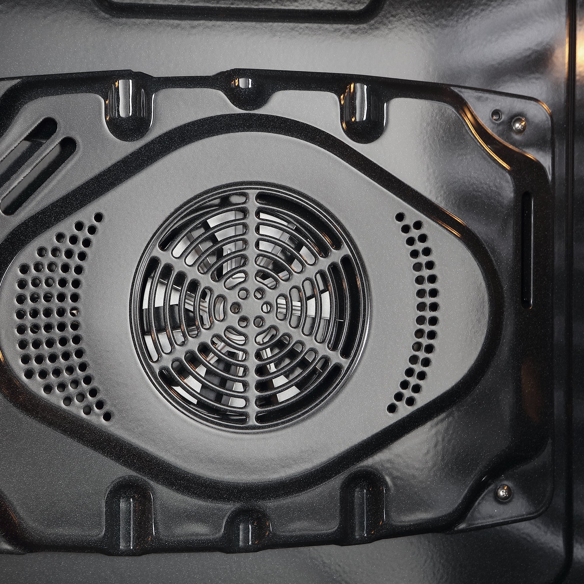 Oven cavity fan and vent with circular grill and perforated side openings