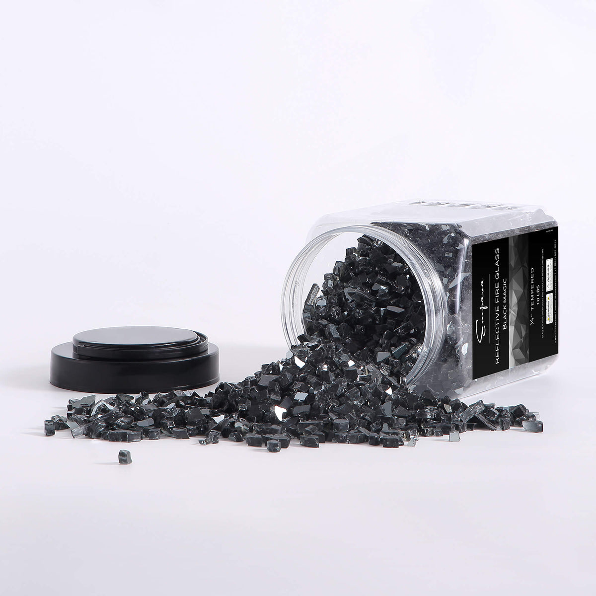 Reflective tempered fire glass in black, with glass shards spilled on a surface