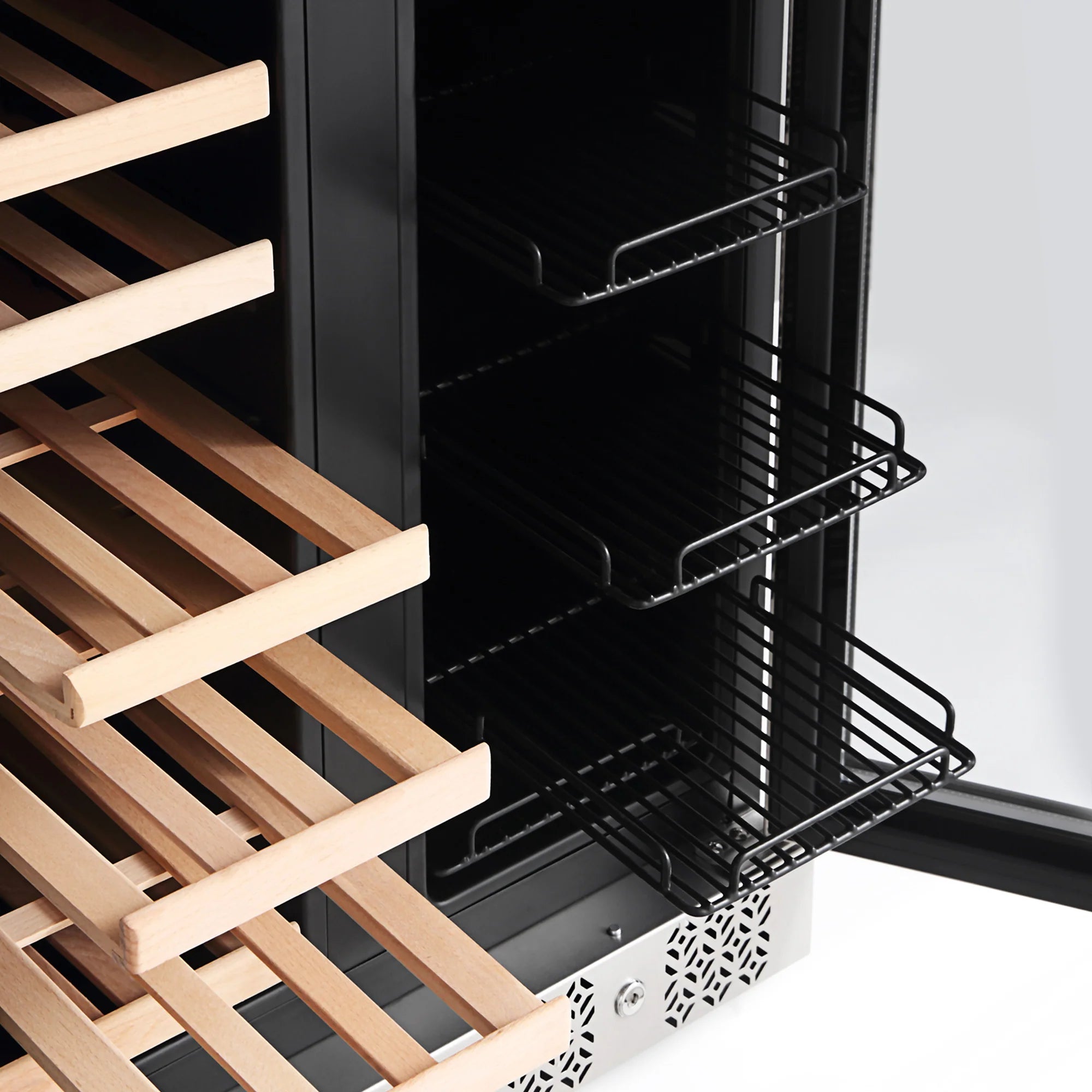 Open stainless steel wine cooler interior with wire shelves and wooden bottle rack