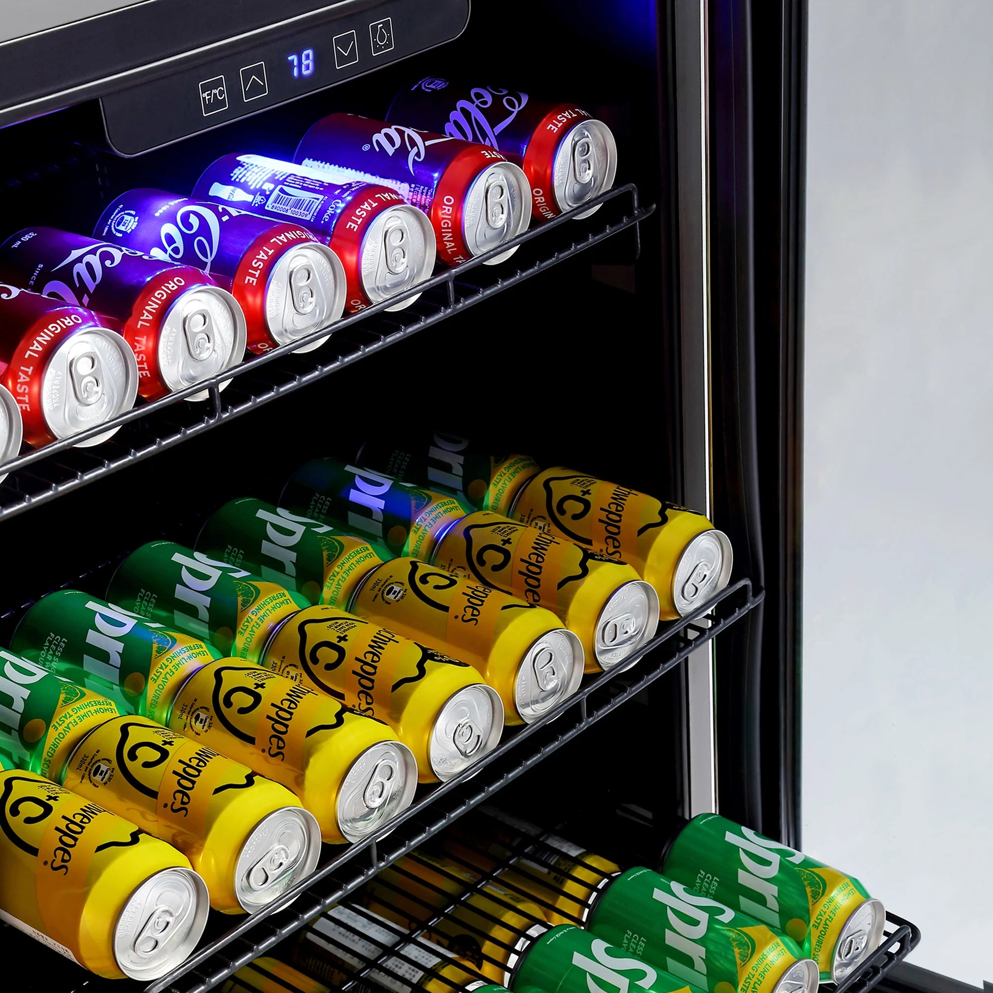 Beverage fridge shelf with colorful soda cans and blue interior light