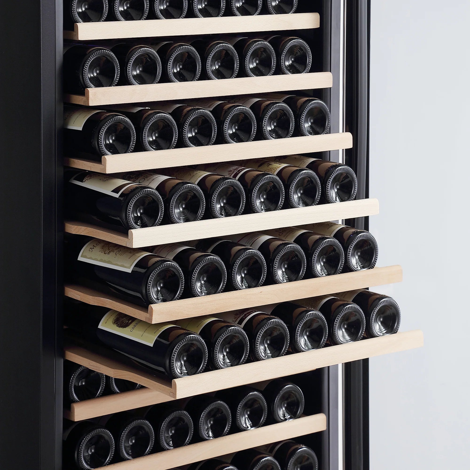Close-up of wine bottle cooler shelves holding bottles in multiple rows
