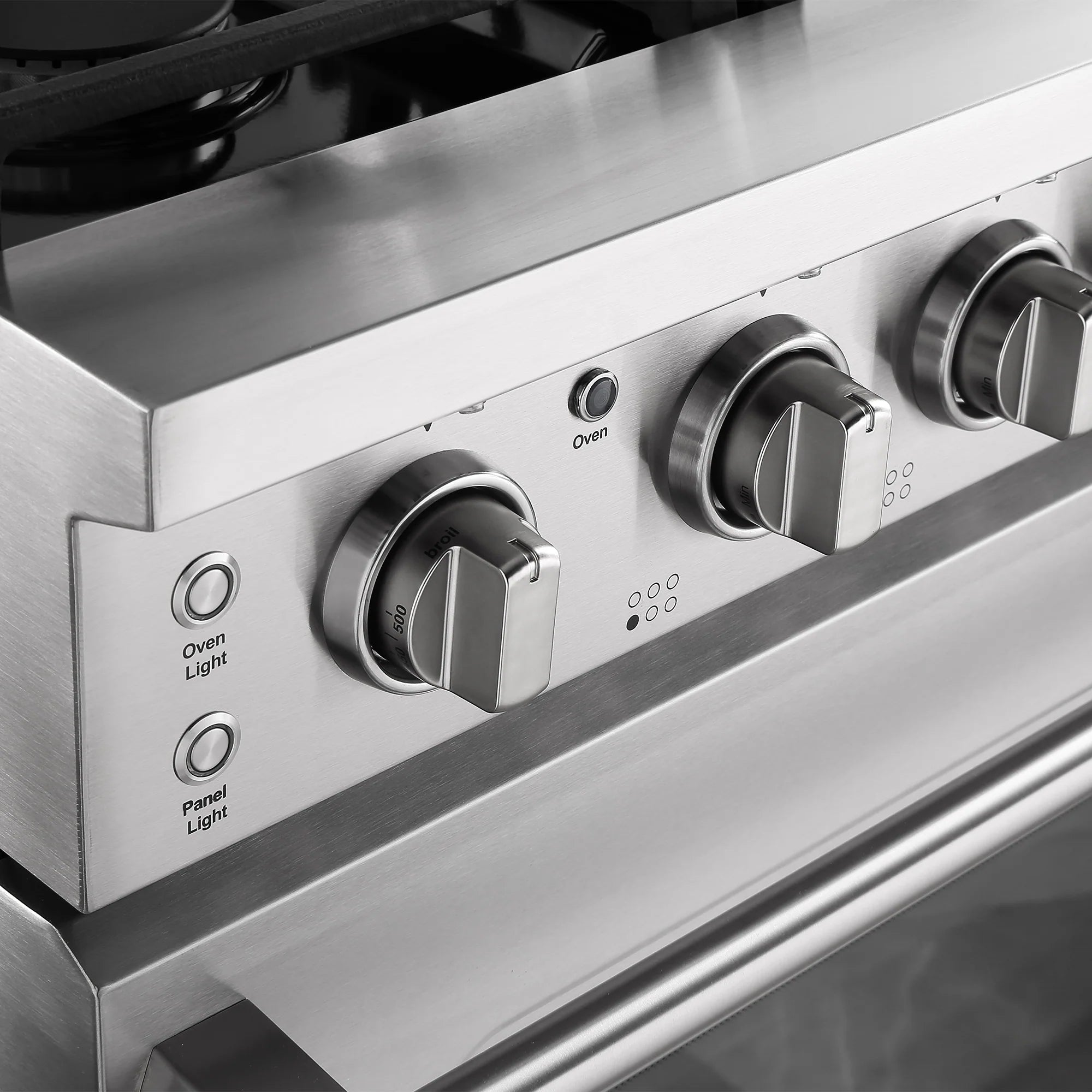Stainless steel oven control panel with labeled knobs and indicator lights