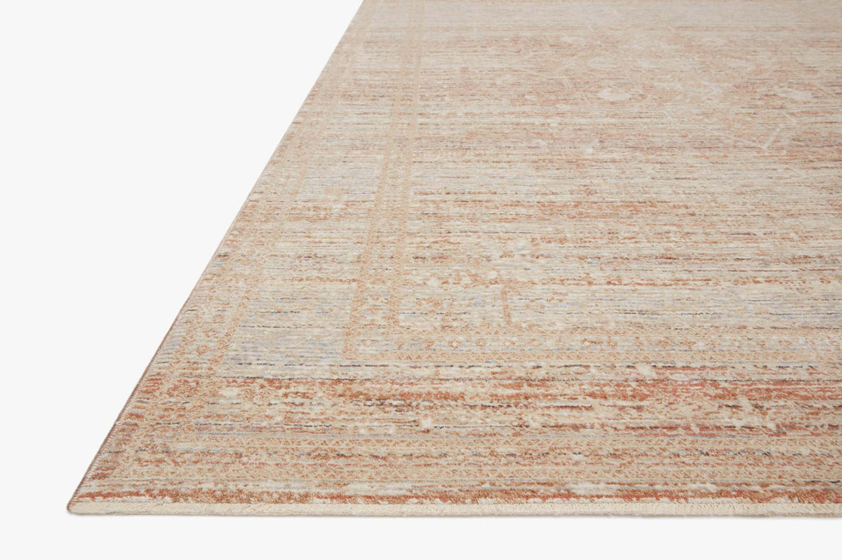 Power loomed rug corner, distressed geometric design in terracotta and muted blue
