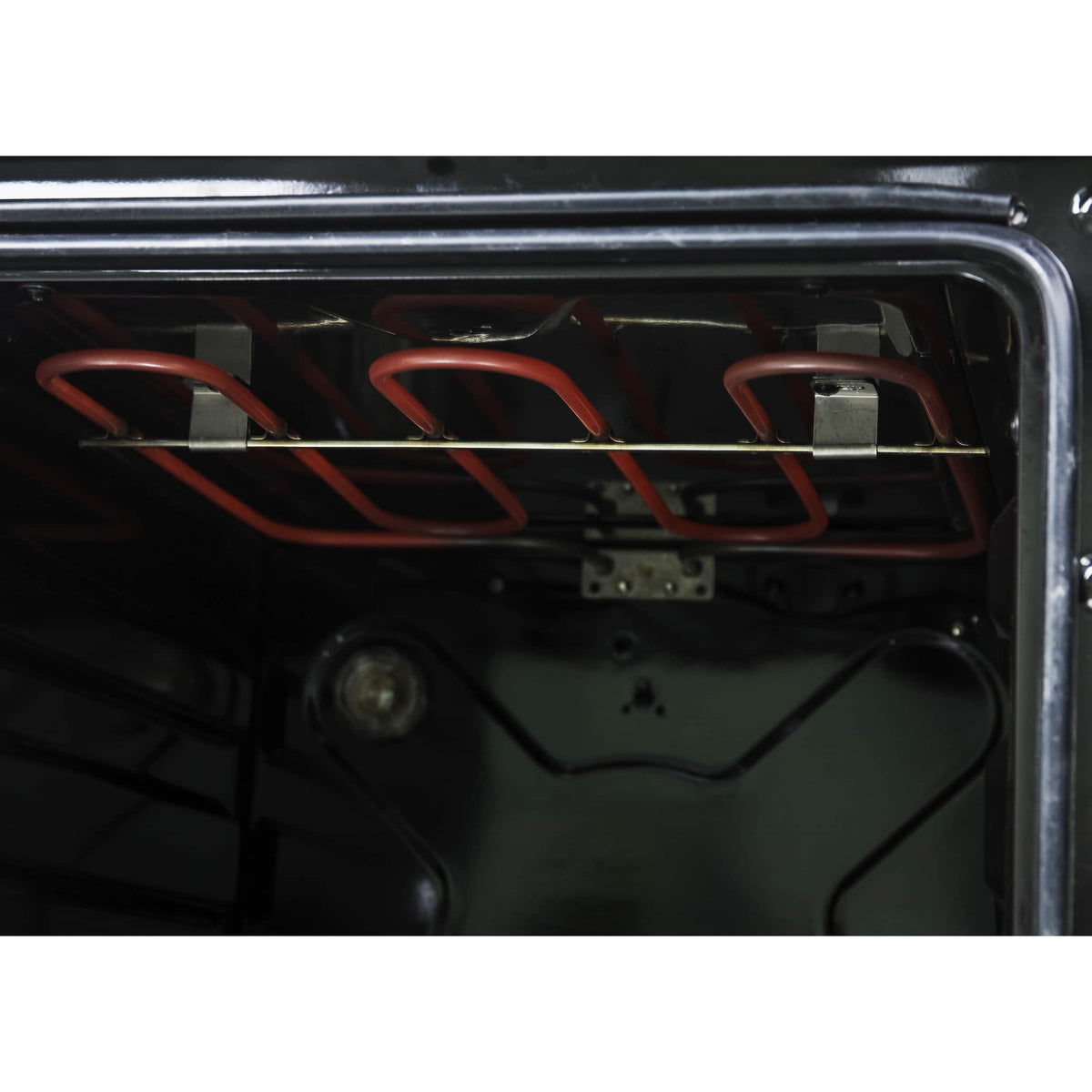 Electric oven interior with visible heating element and metal rack guides
