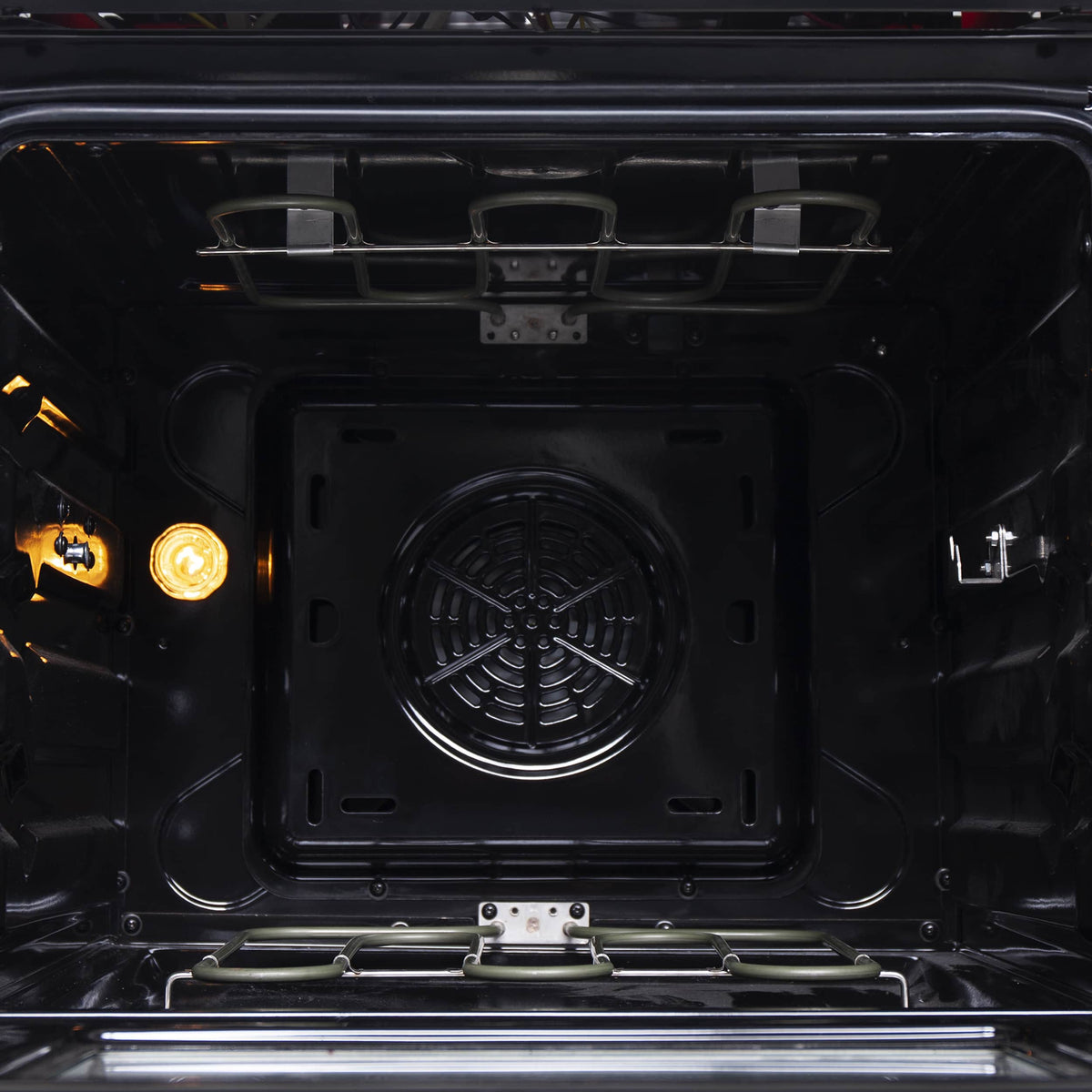 Electric oven interior view with square heating element and grill-style rack above floor