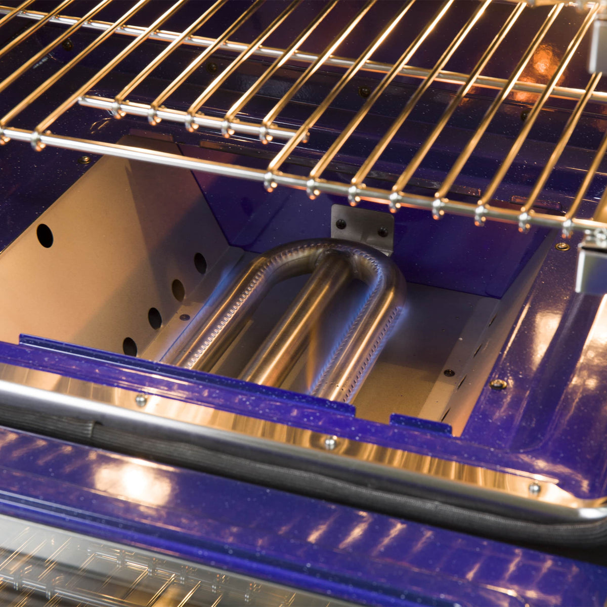 Open oven interior with wire racks and metal heating elements