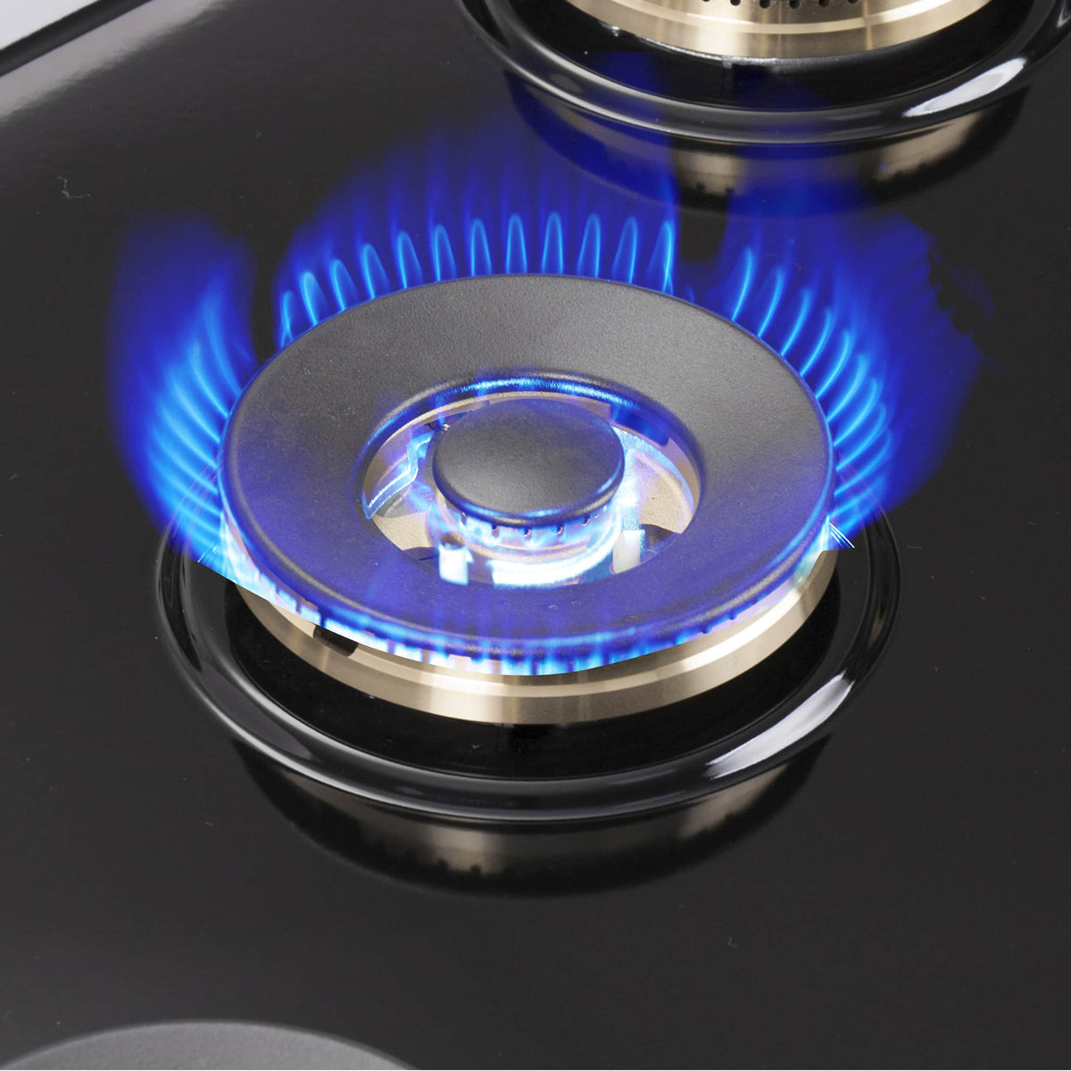 Gas burner with blue flame on stainless cooktop