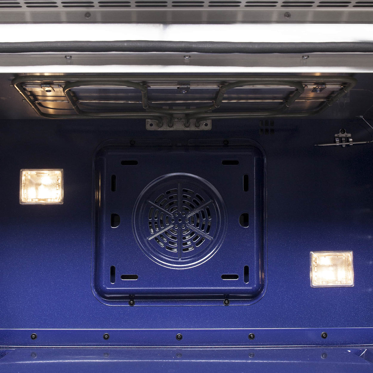 Gas oven rear interior with circular convection fan housing and glowing heating elements
