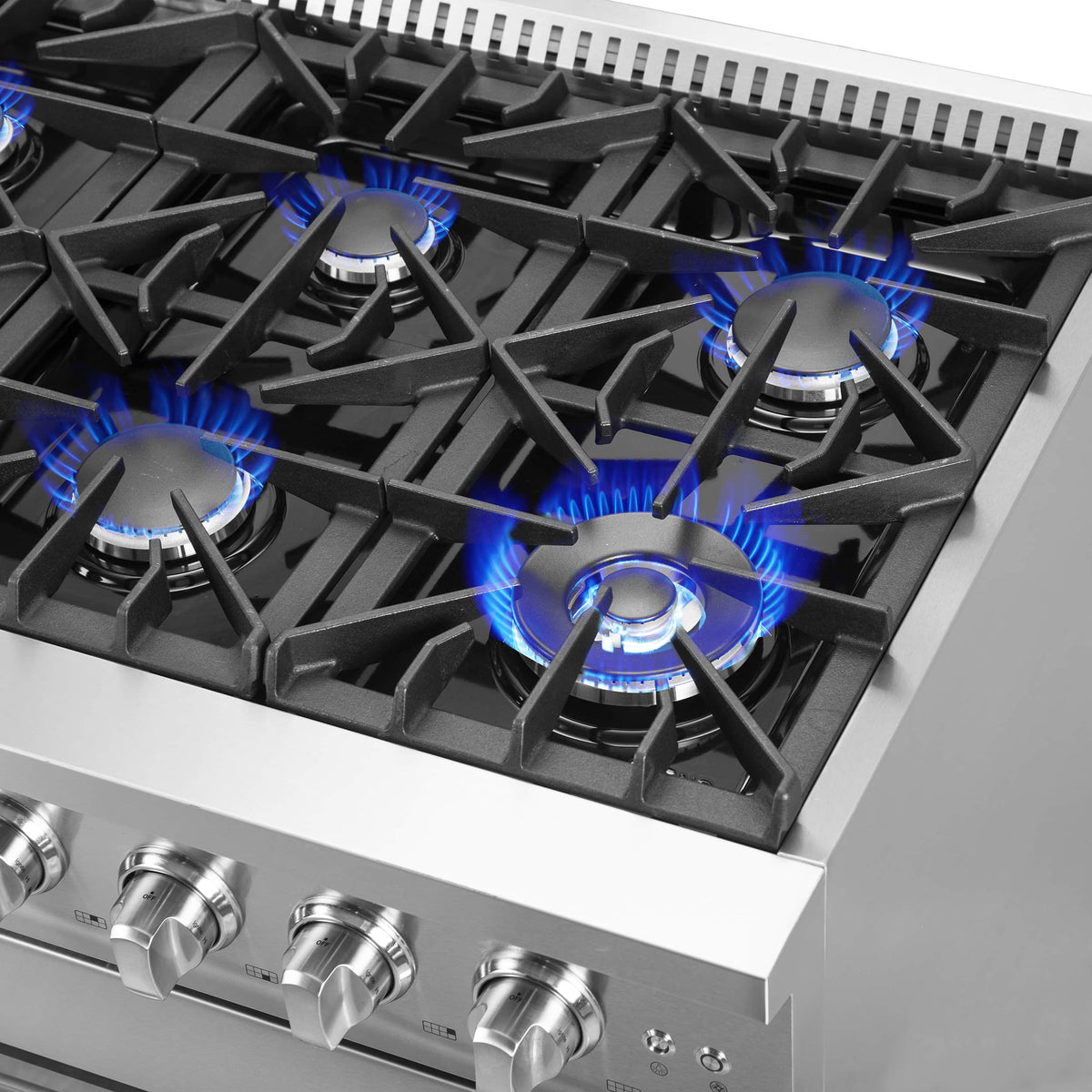 Stainless steel gas cooktop with multiple burners and blue flame ignition