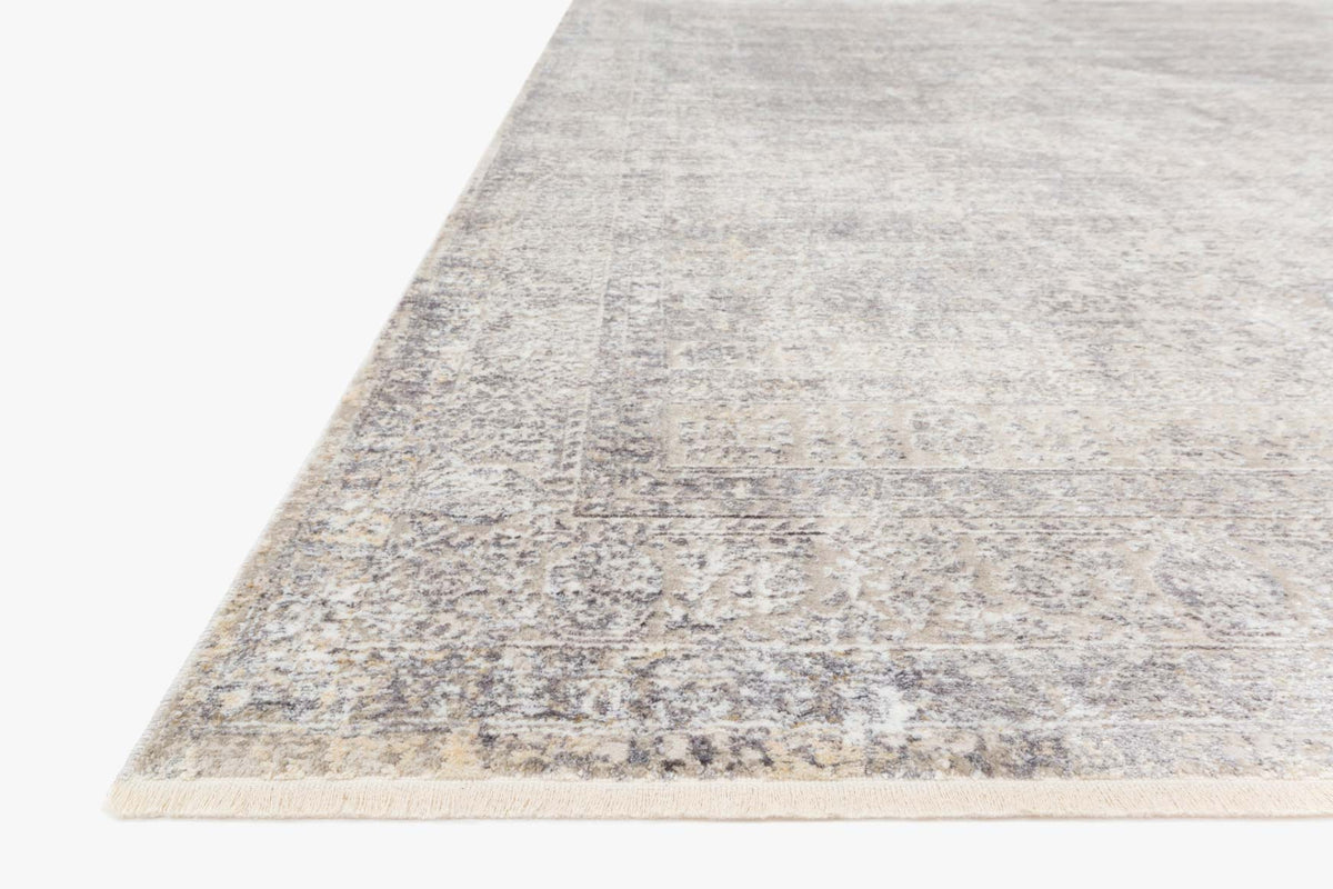 Silver & pebble power-loomed rug corner with low-pile distressed border and abstract texture