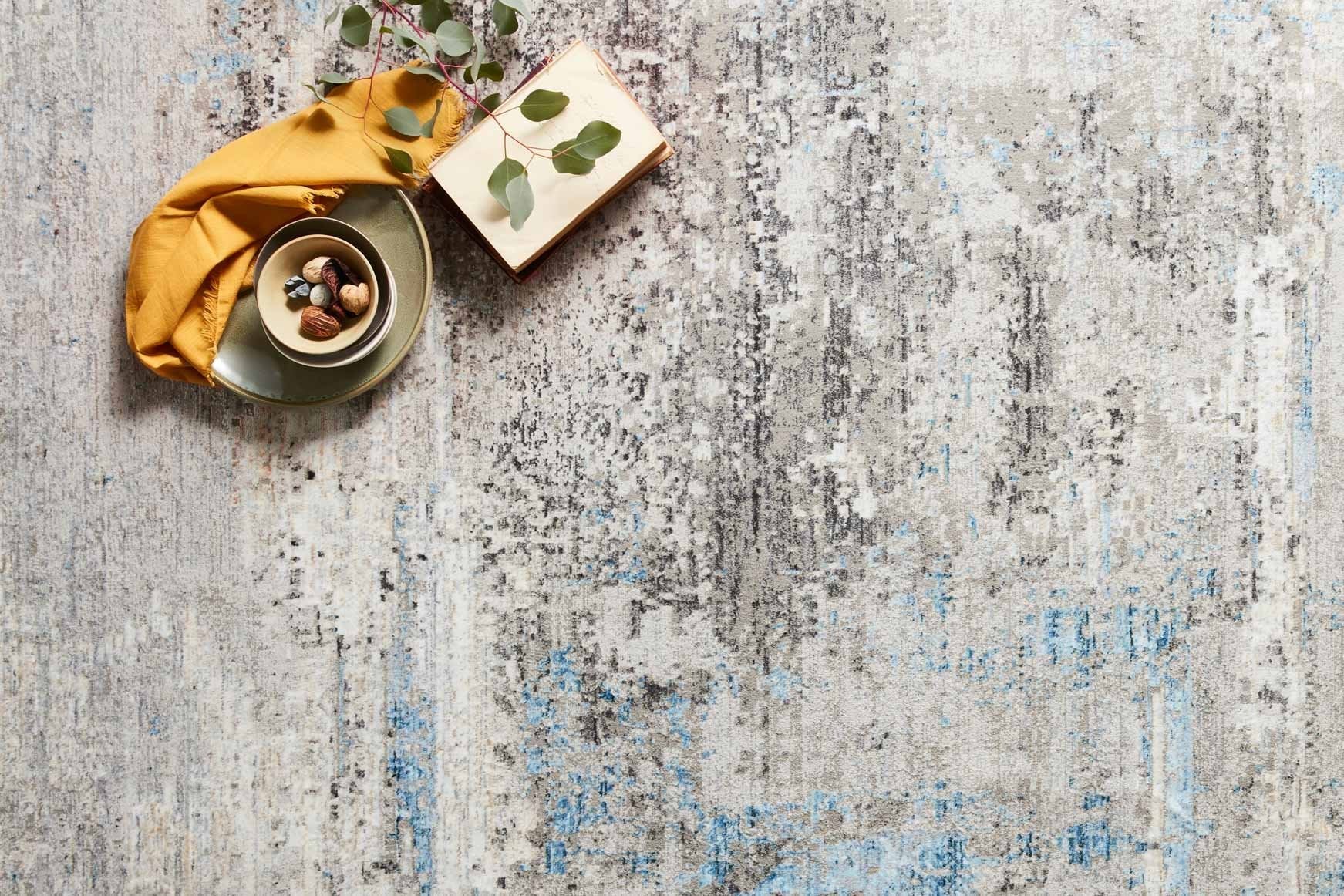 Grey and ocean blue power-loomed rug close-up with distressed abstract lines