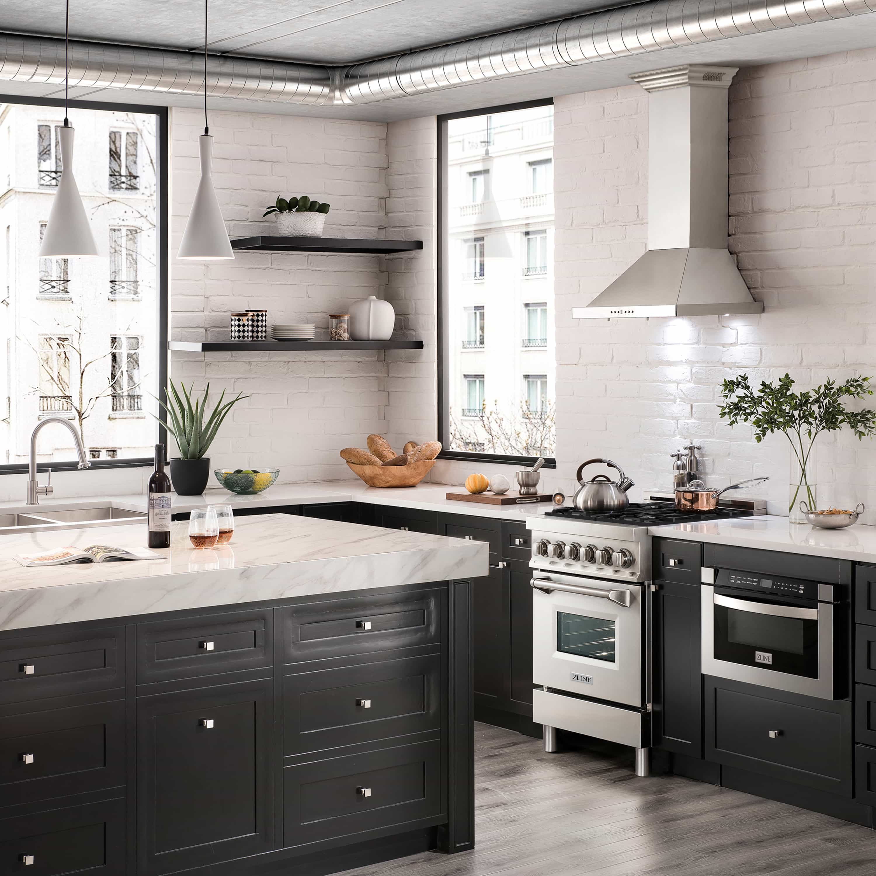 Stainless steel dual fuel range in a modern kitchen with hood and cabinetry