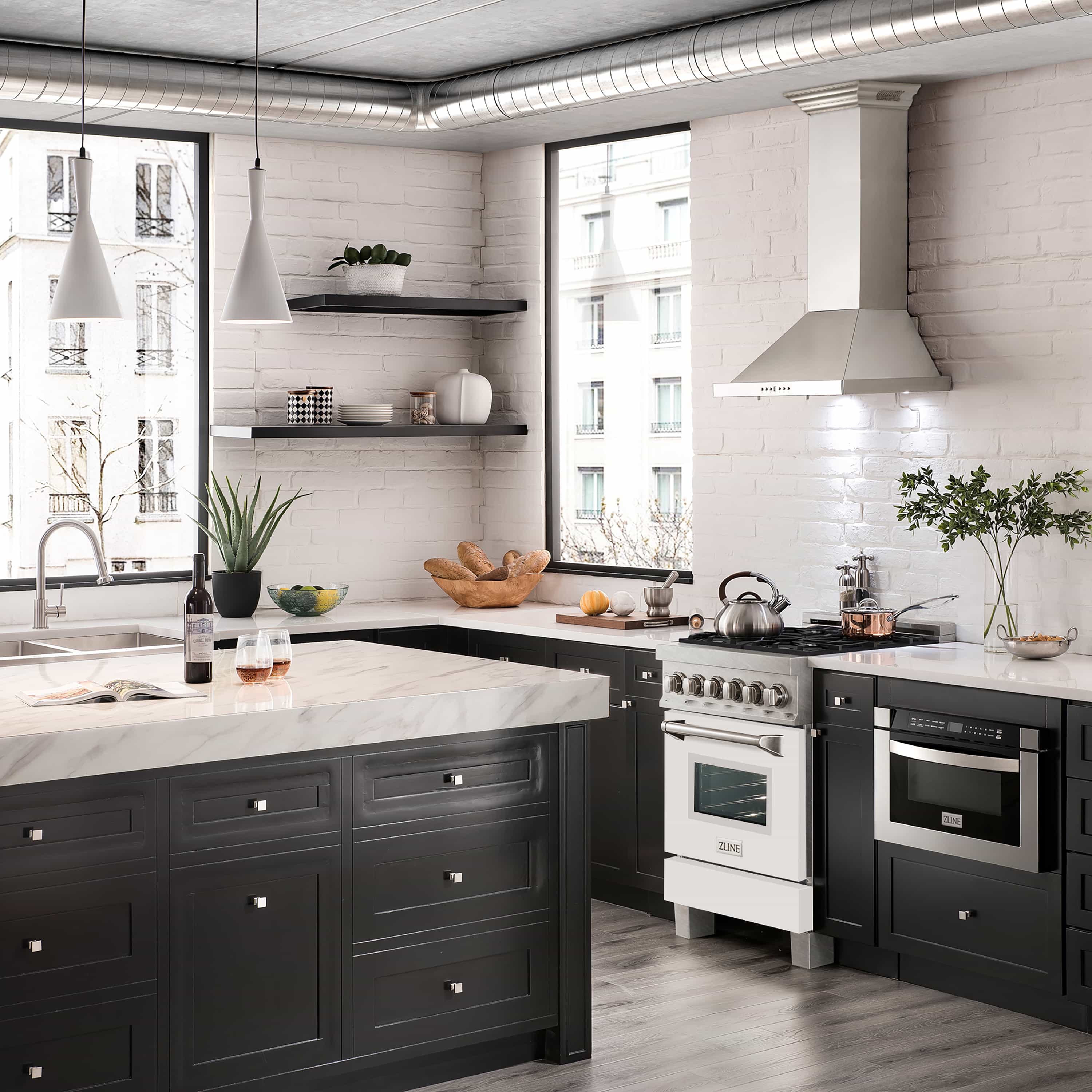 Dual fuel range in kitchen with satin stainless cooktop and white matte cabinet doors