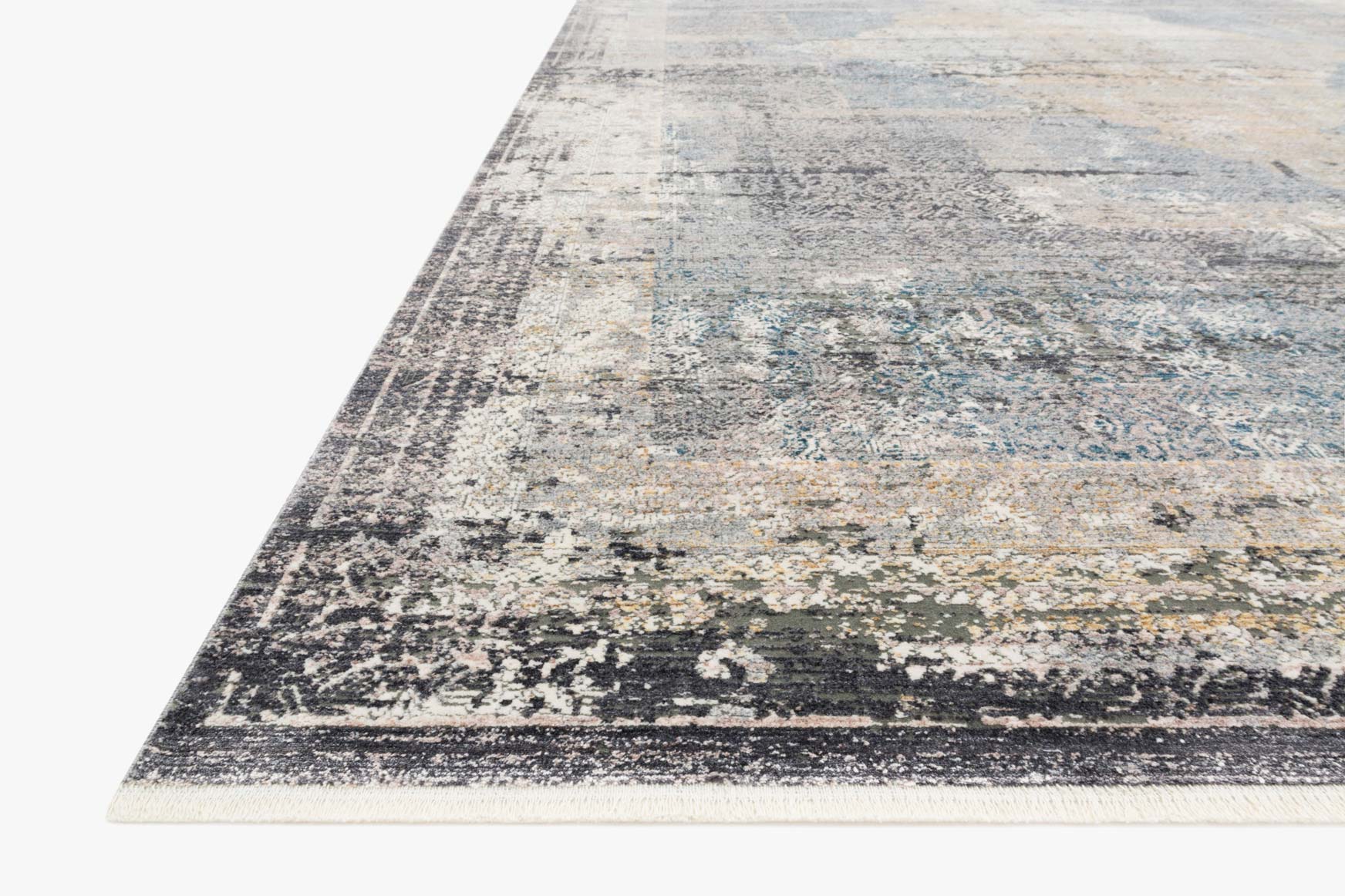 Traditional power-loomed rug, angled view, distressed motif in grey, blue, and charcoal.