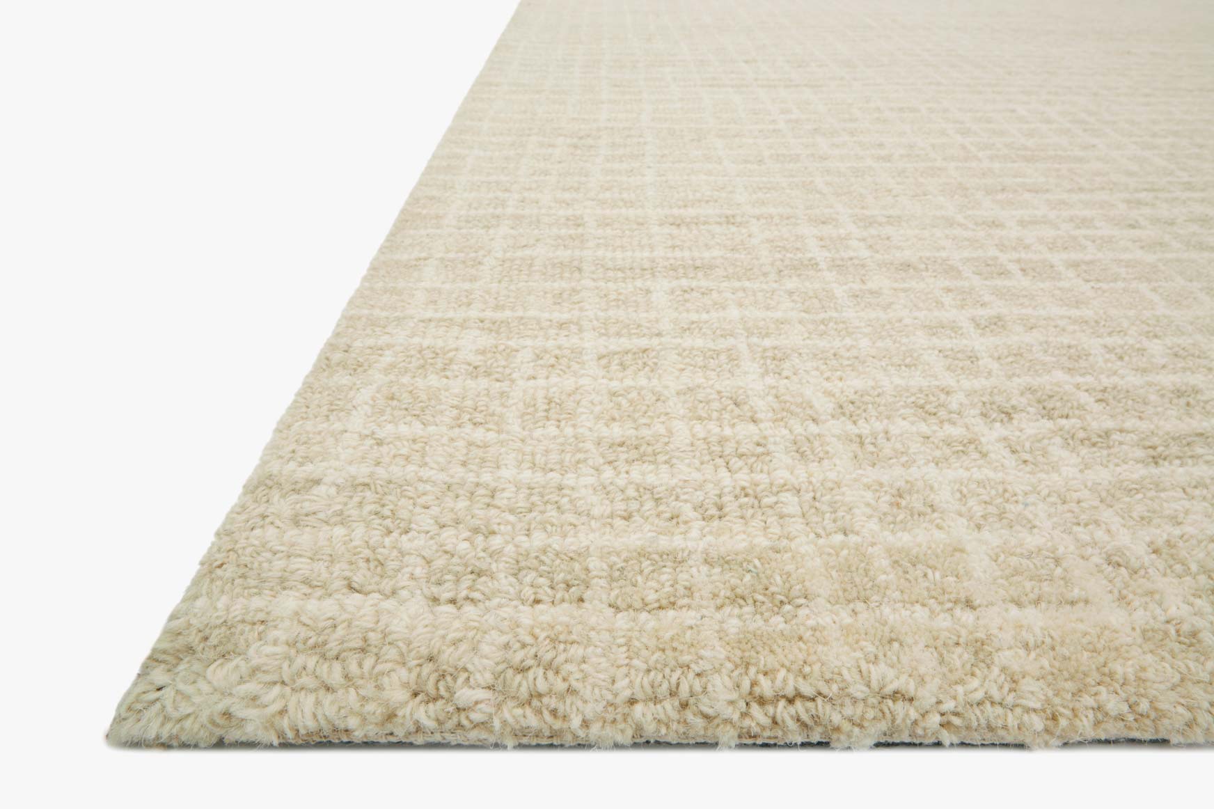 Antique ivory hooked area rug with textured grid pile and angled corner edge