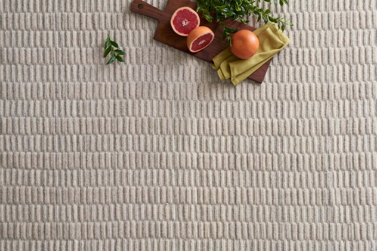 Oatmeal hand-loomed rug with repeating ribbed texture