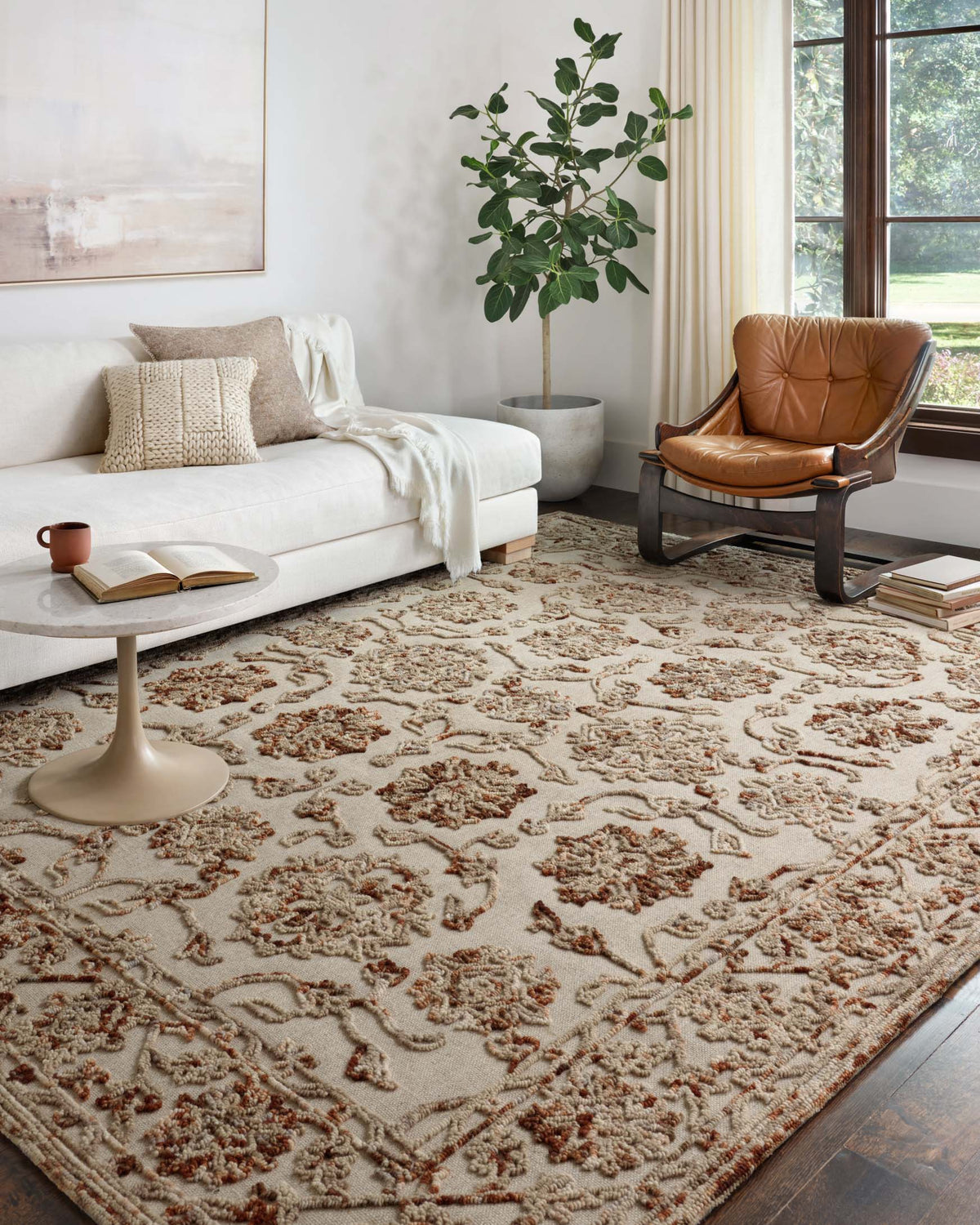 Taupe and rust hooked rug with detailed floral medallion pattern, full area view