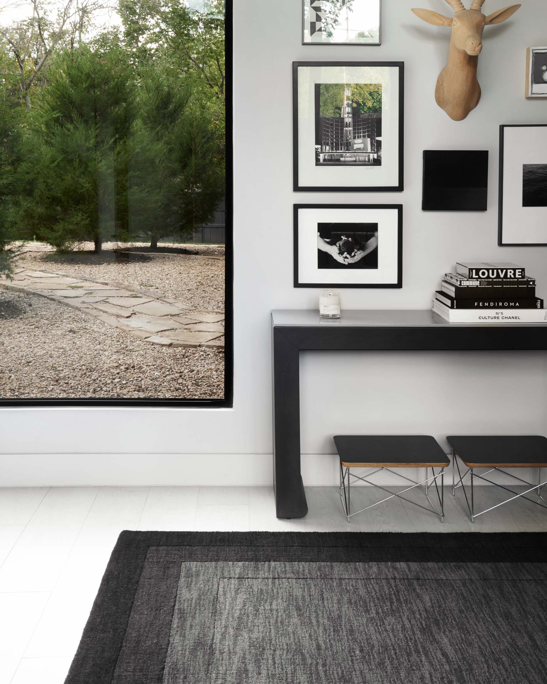 Rectangular grey and charcoal rug with subtle woven texture and framed design