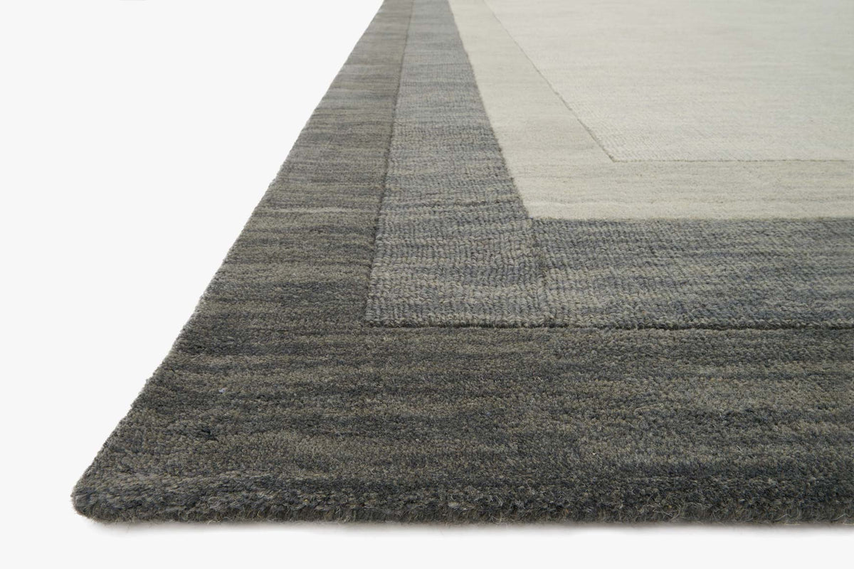 Slate gray transitional rug corner with textured low-pile weave and light stripe