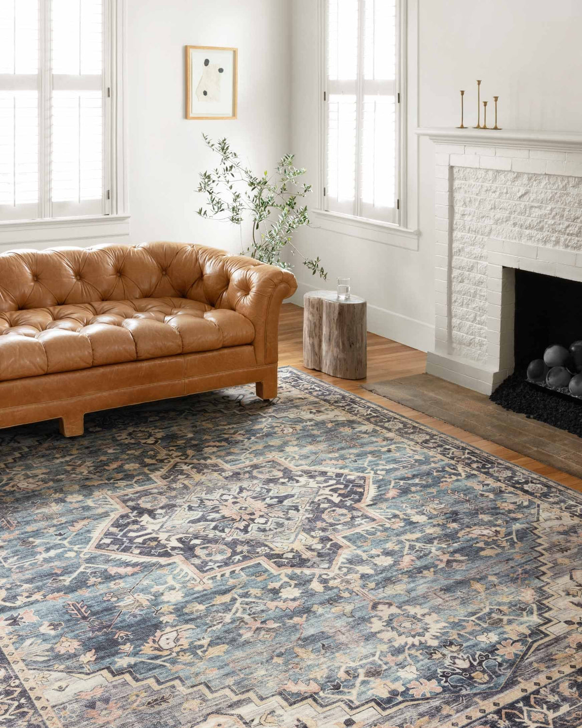 Traditional navy-and-light blue patterned rug laid across living room floor