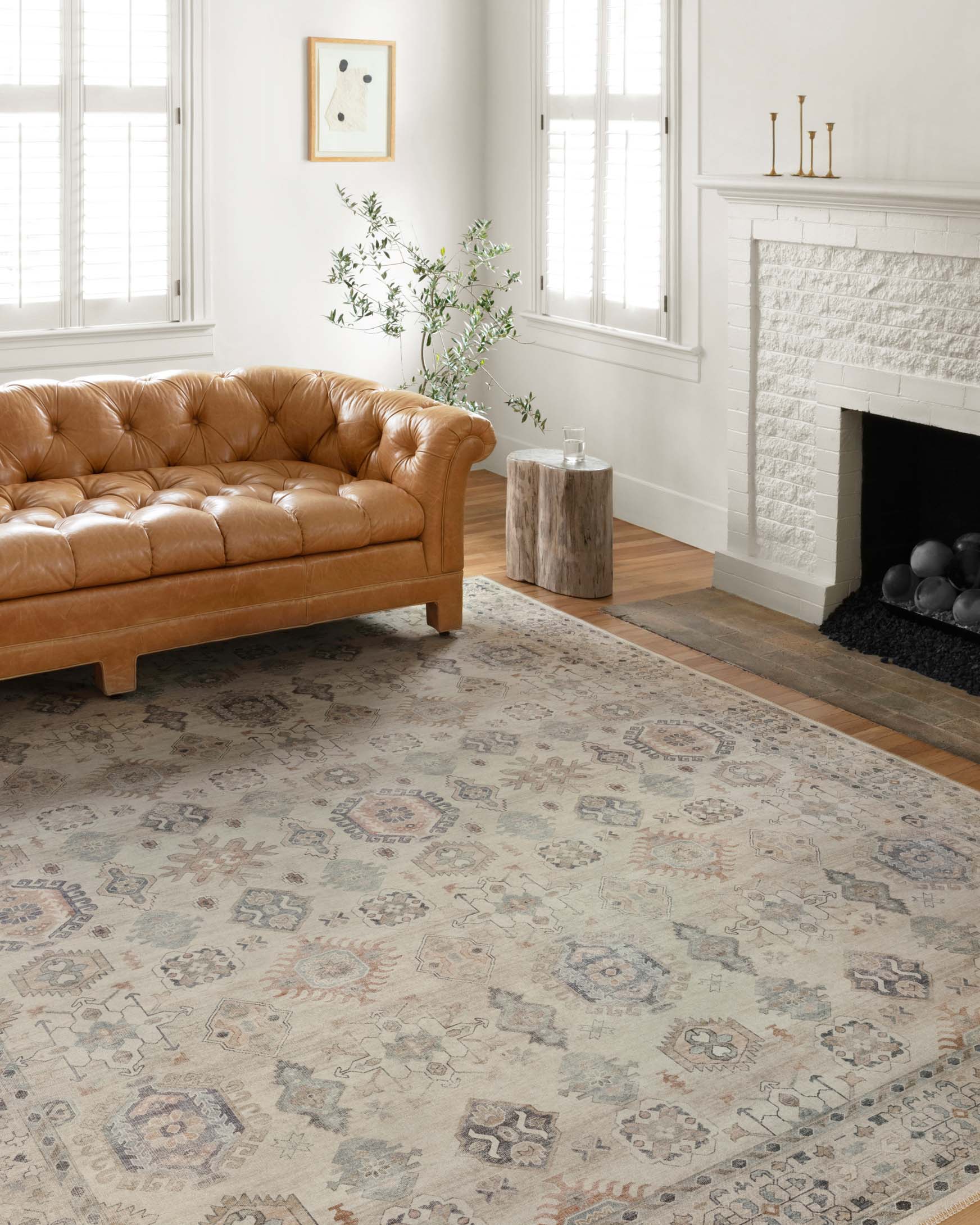 Traditional power-loomed beige rug with ornate geometric motifs in a living room