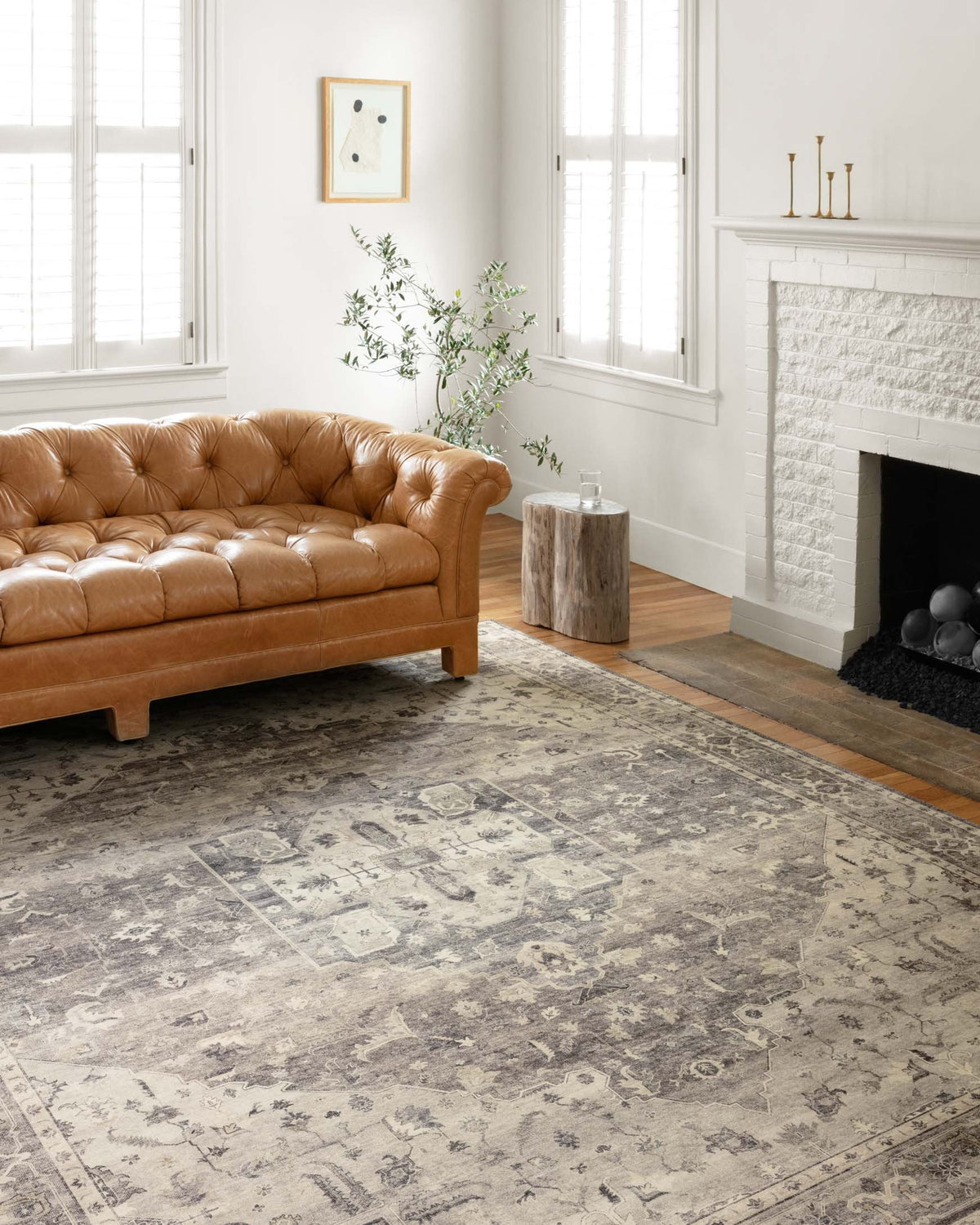 Steel and ivory traditional power-loomed area rug styled in a living room with sofa