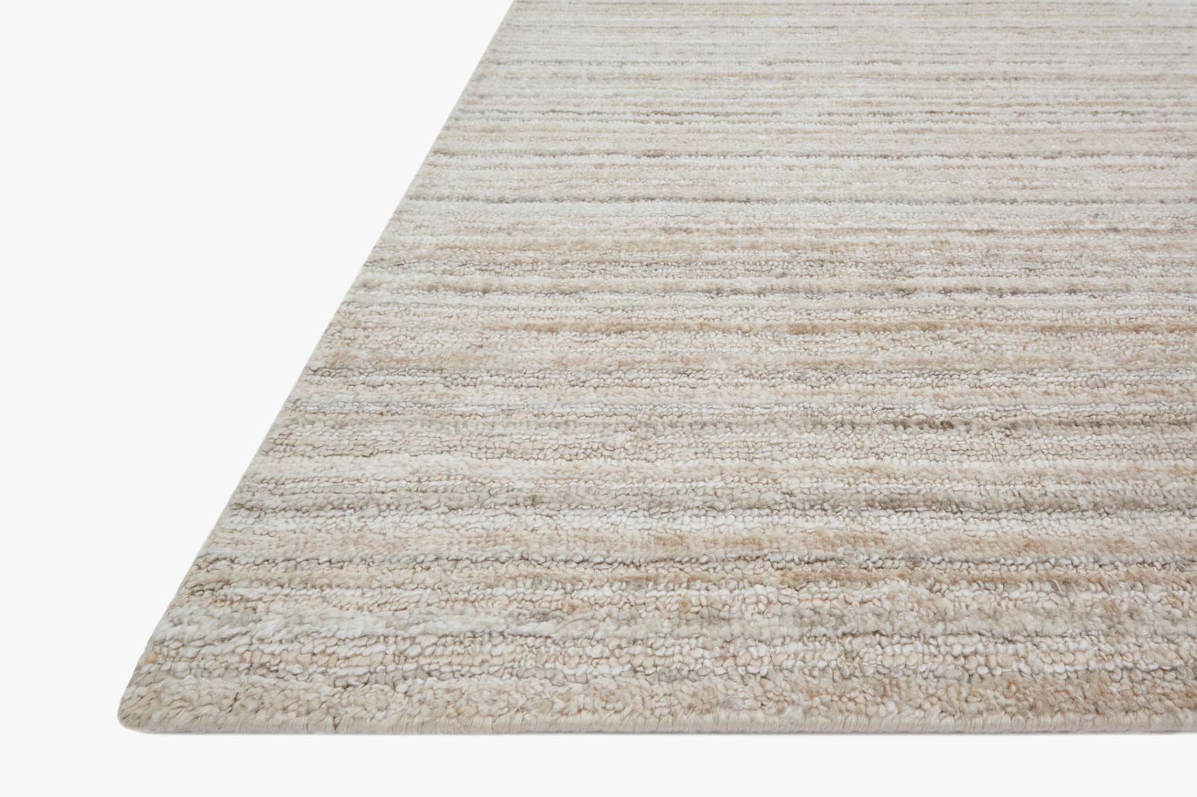Hand-loomed ivory and natural rug with subtle horizontal stripes, corner close-up