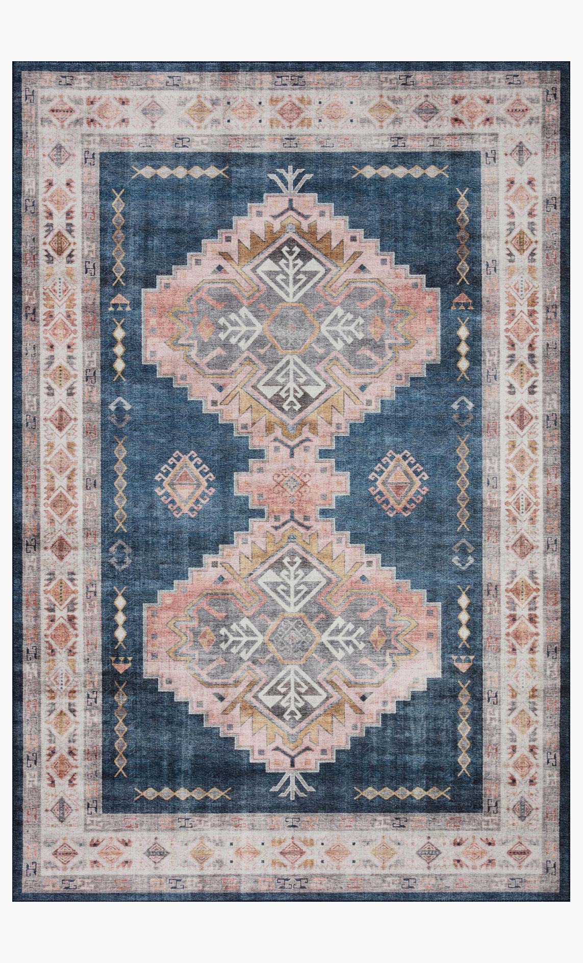 Traditional rug in navy blue with blush and cream diamond motifs and ornate medallions