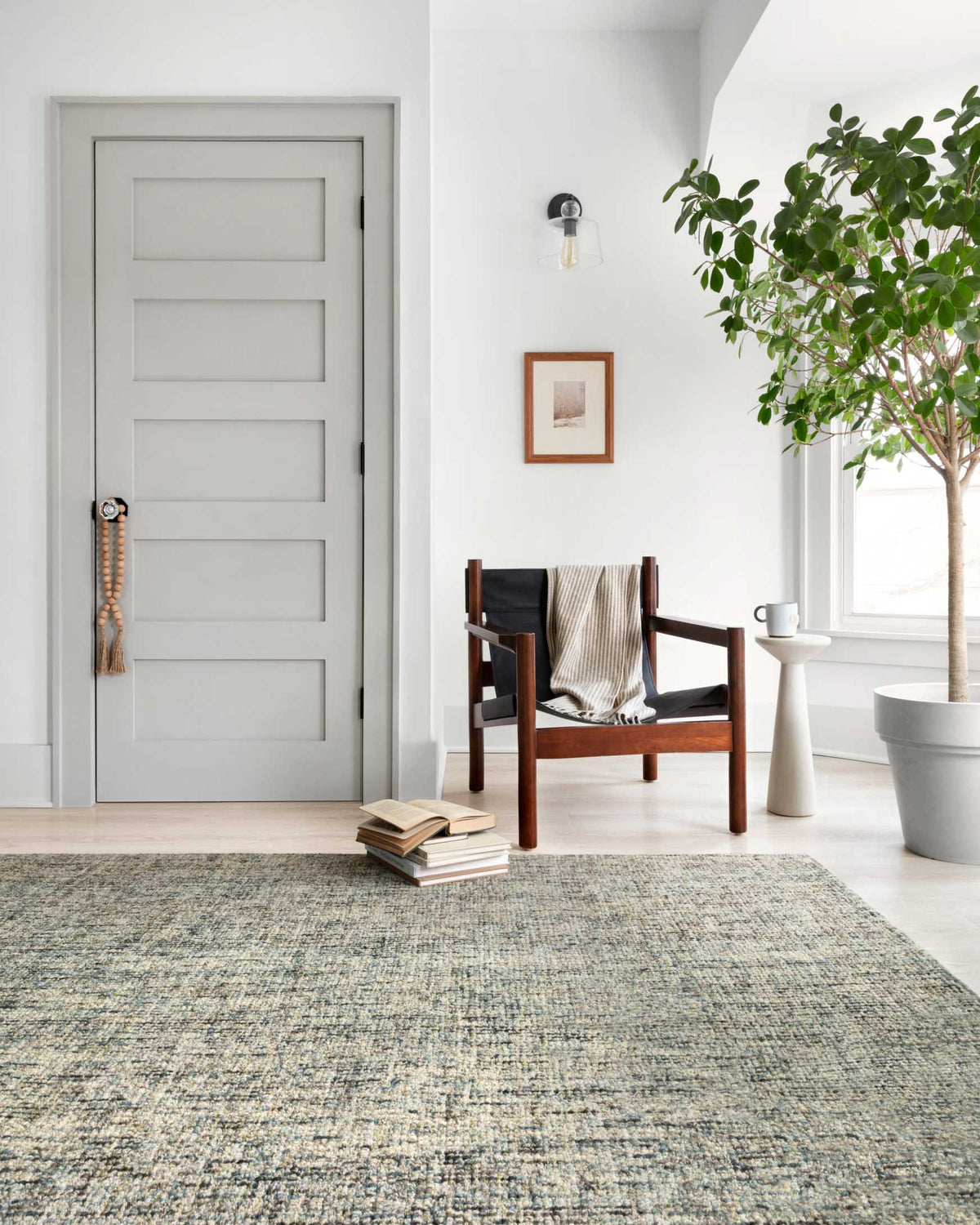 Hand-tufted area rug in ocean blue and sand with dense textured weave