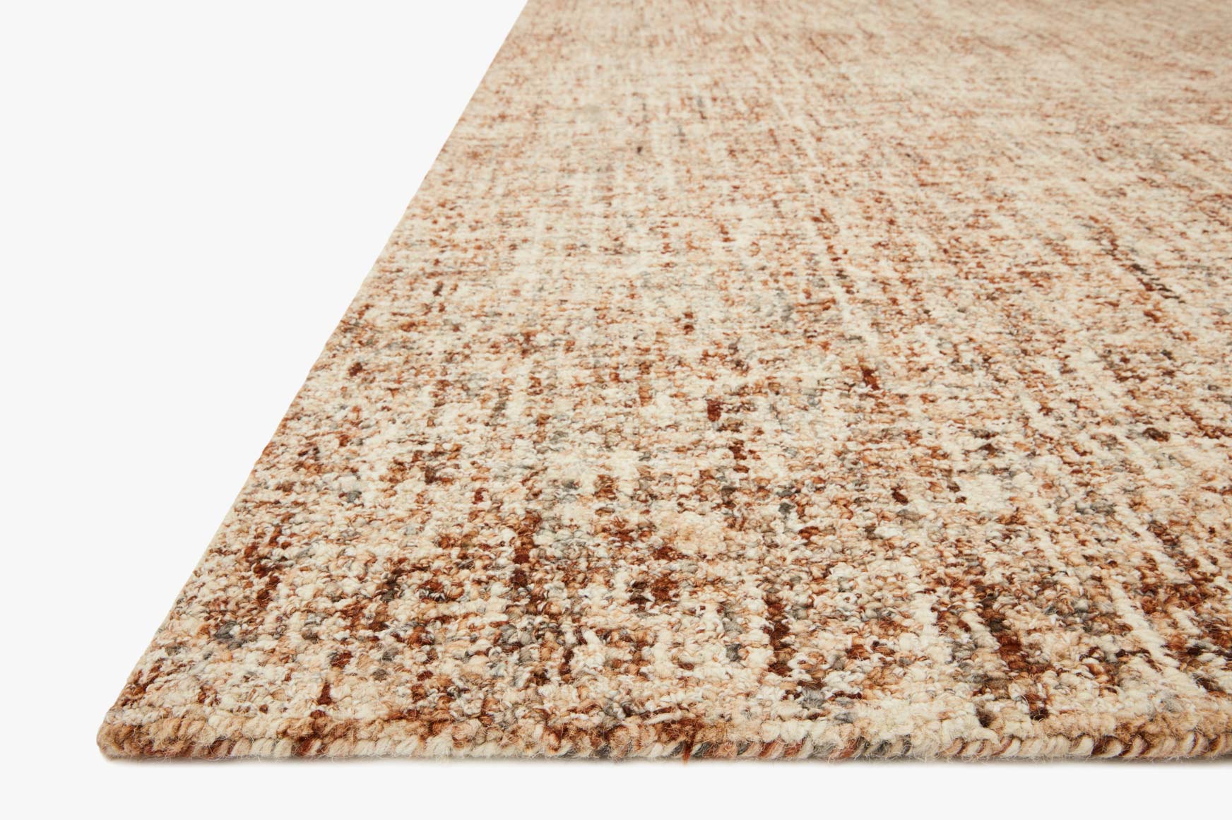 Rust-and-charcoal speckled rug corner with low pile and textured border edge