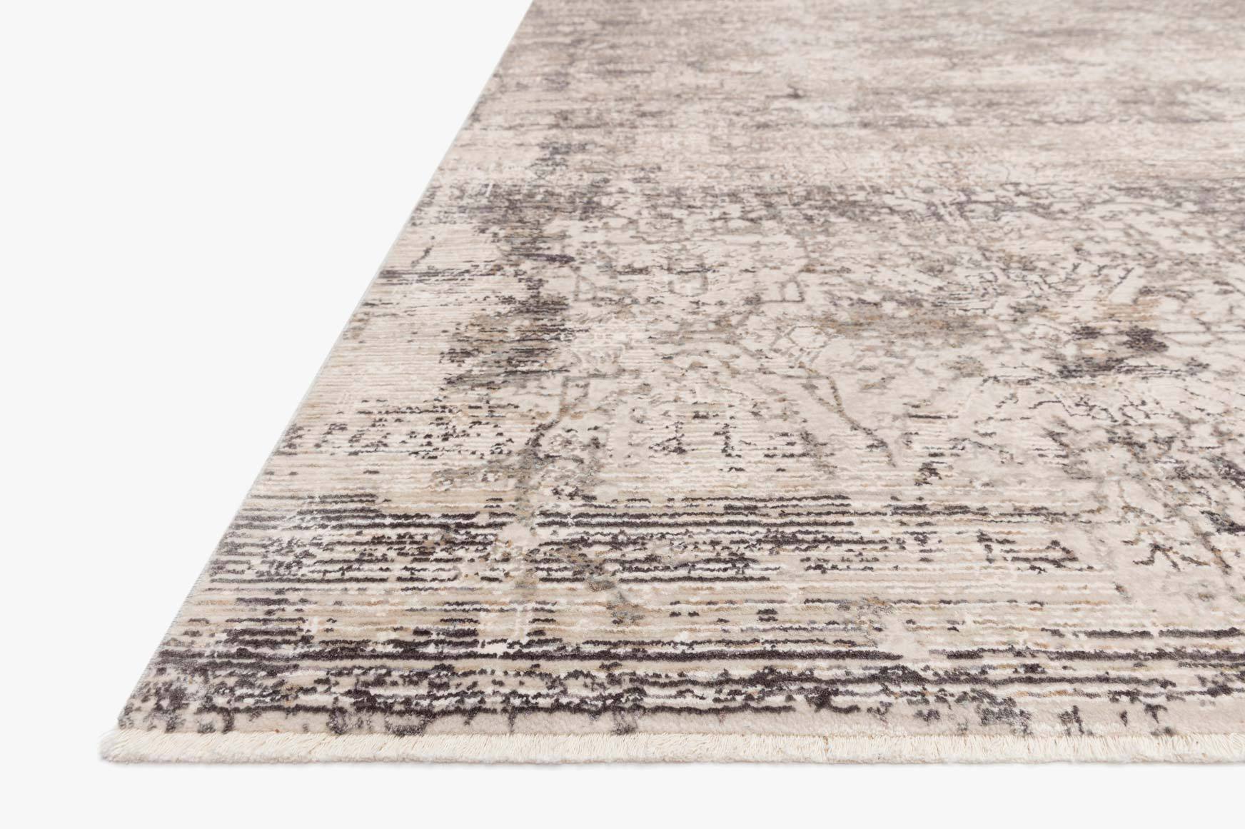 Transitional power-loomed rug corner with layered distressed lines in graphite and beige.