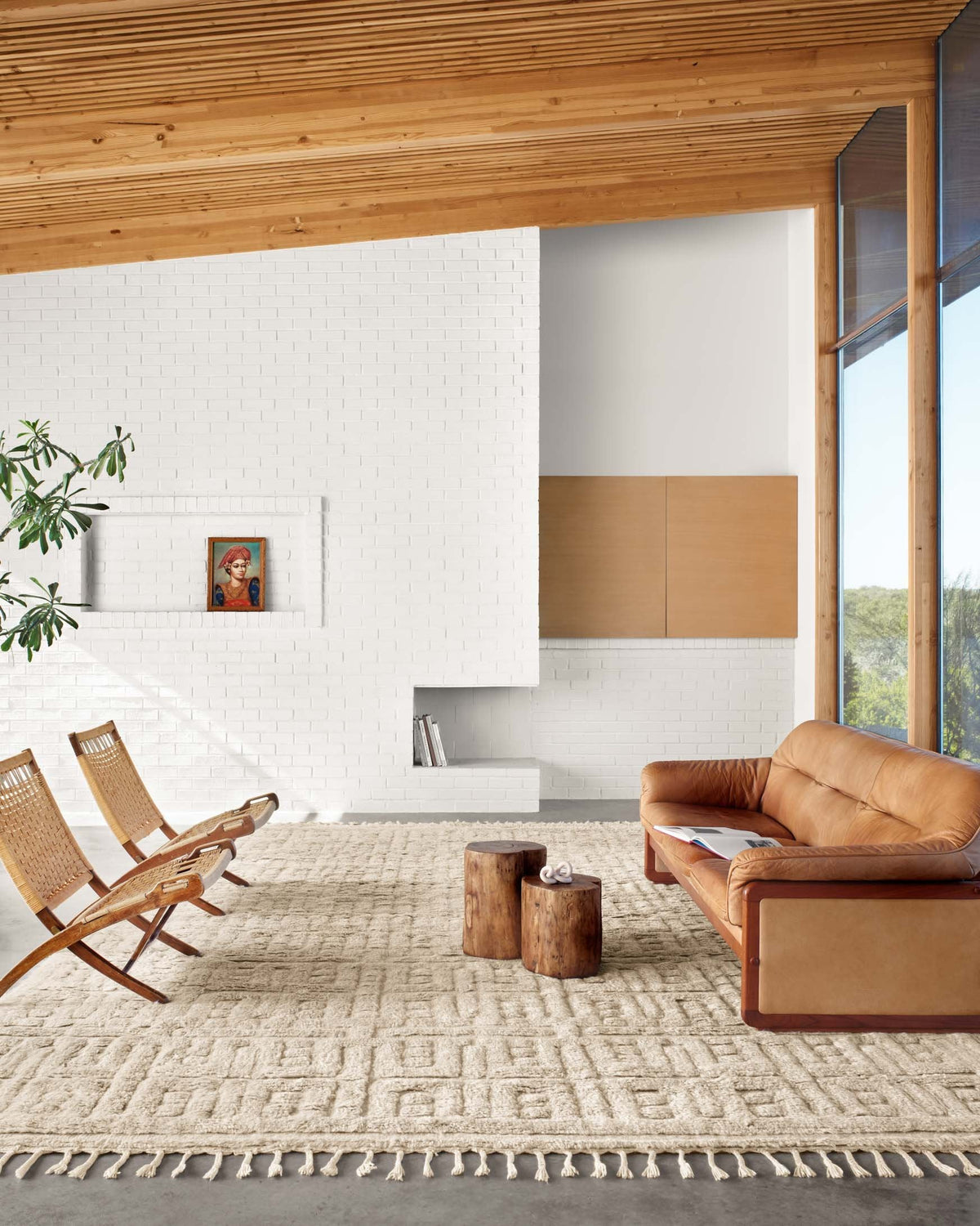 Oatmeal beige rug with repeating geometric motif and short tasseled fringe