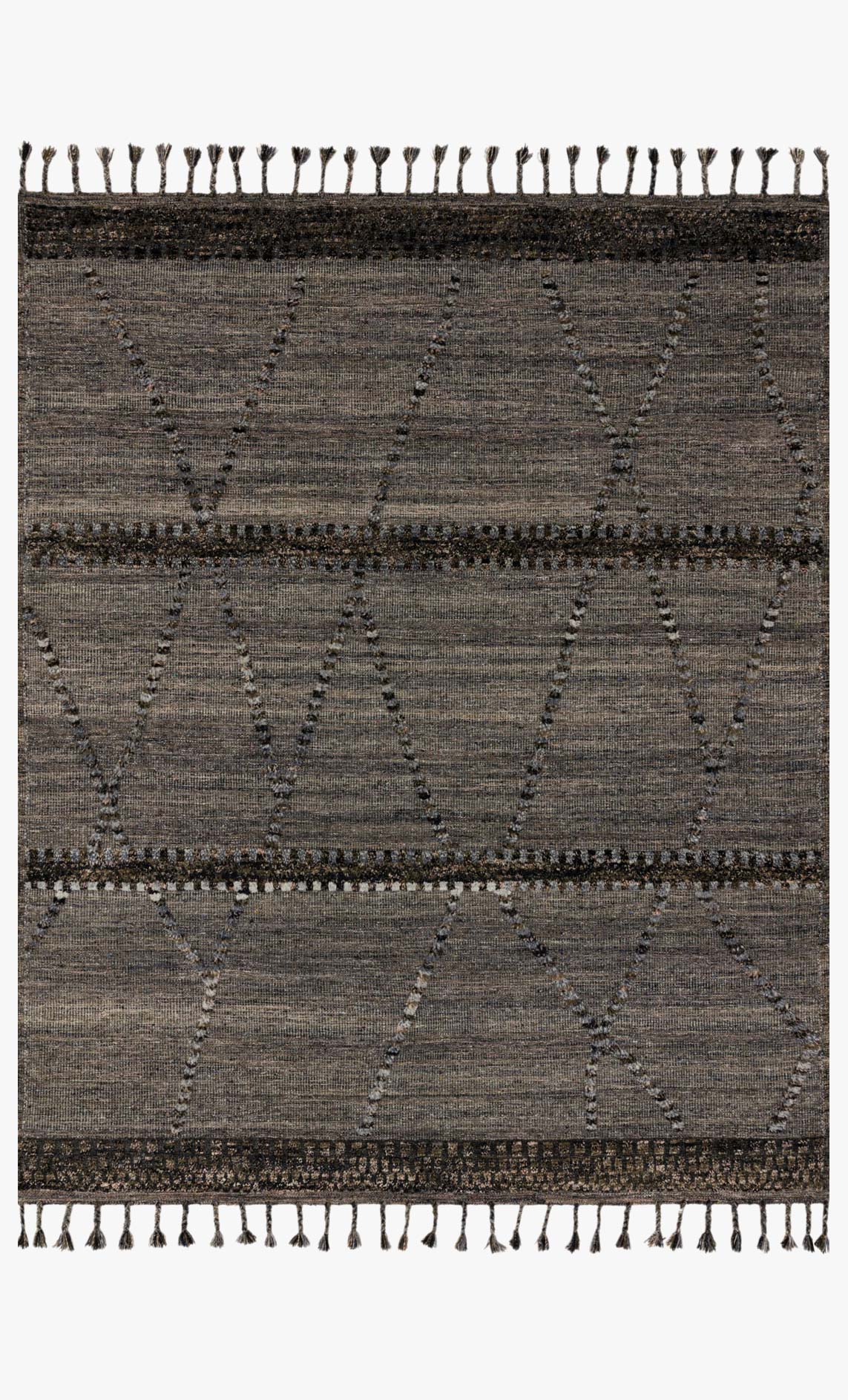 Grey area rug with repeating chevron lines and short tassel fringe border
