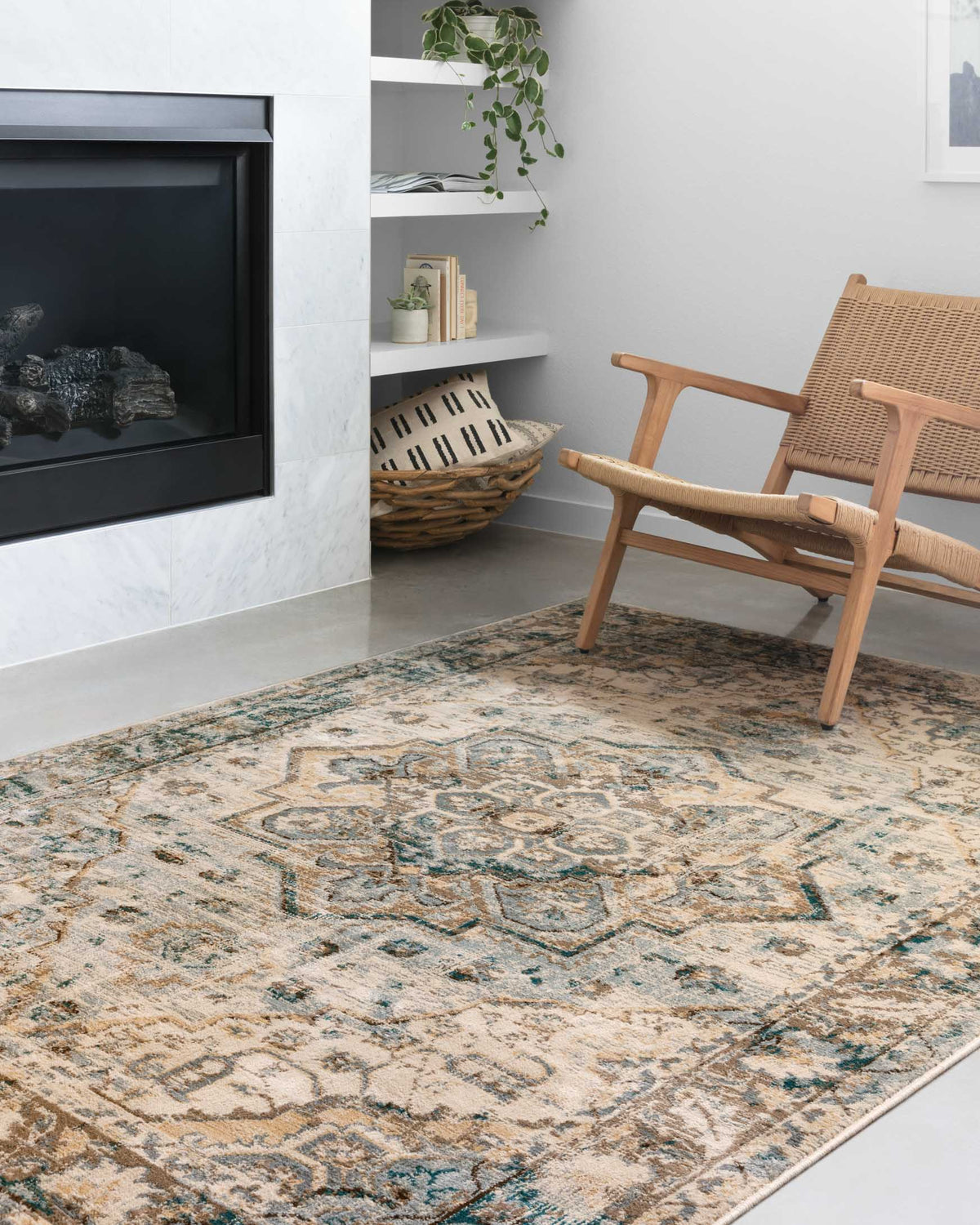 Area rug with distressed medallion motifs in oatmeal, teal, and dark brown border.