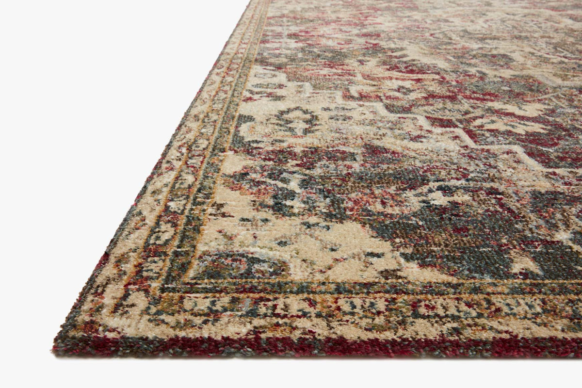 Contemporary power-loomed rug corner close-up, cream ground with navy and burgundy detail