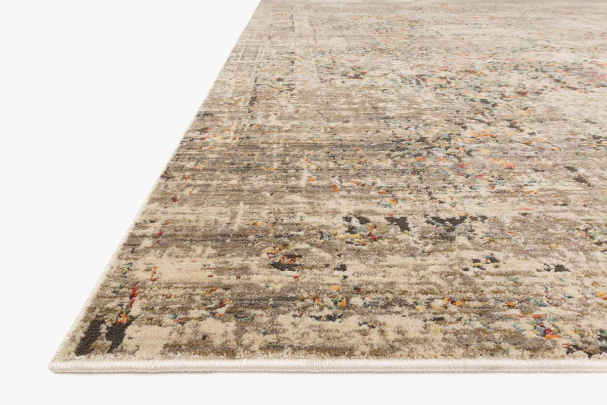 Contemporary power loomed rug, angled view, distressed multicolor pattern and border