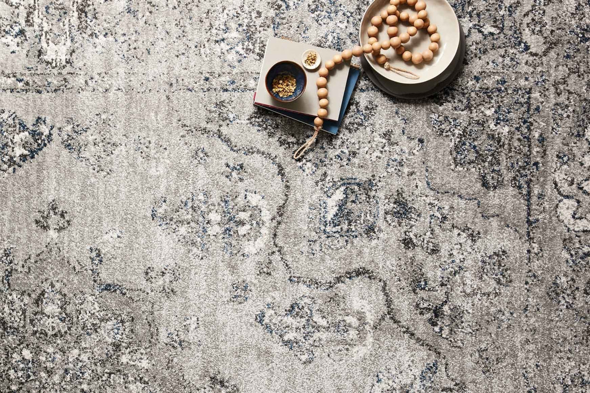 Dove and grey rug with distressed scrolling medallion motifs in blue-grey accents