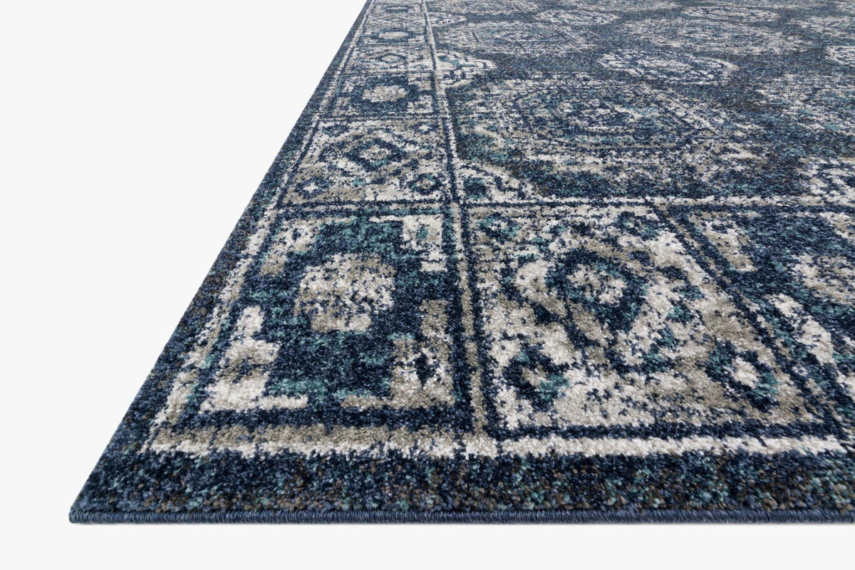 Traditional power-loomed rug corner detail with geometric motifs in denim blue and grey