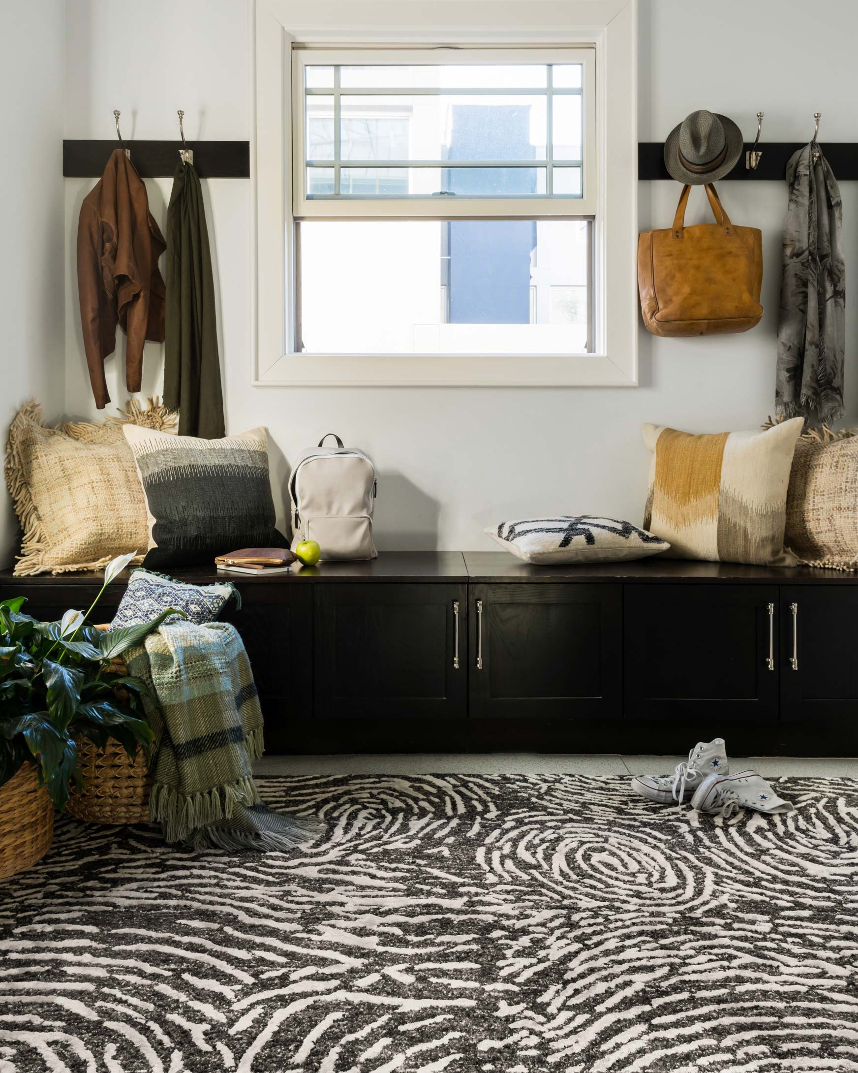 Charcoal and silver patterned hand-tufted rug on floor, zebra swirl design