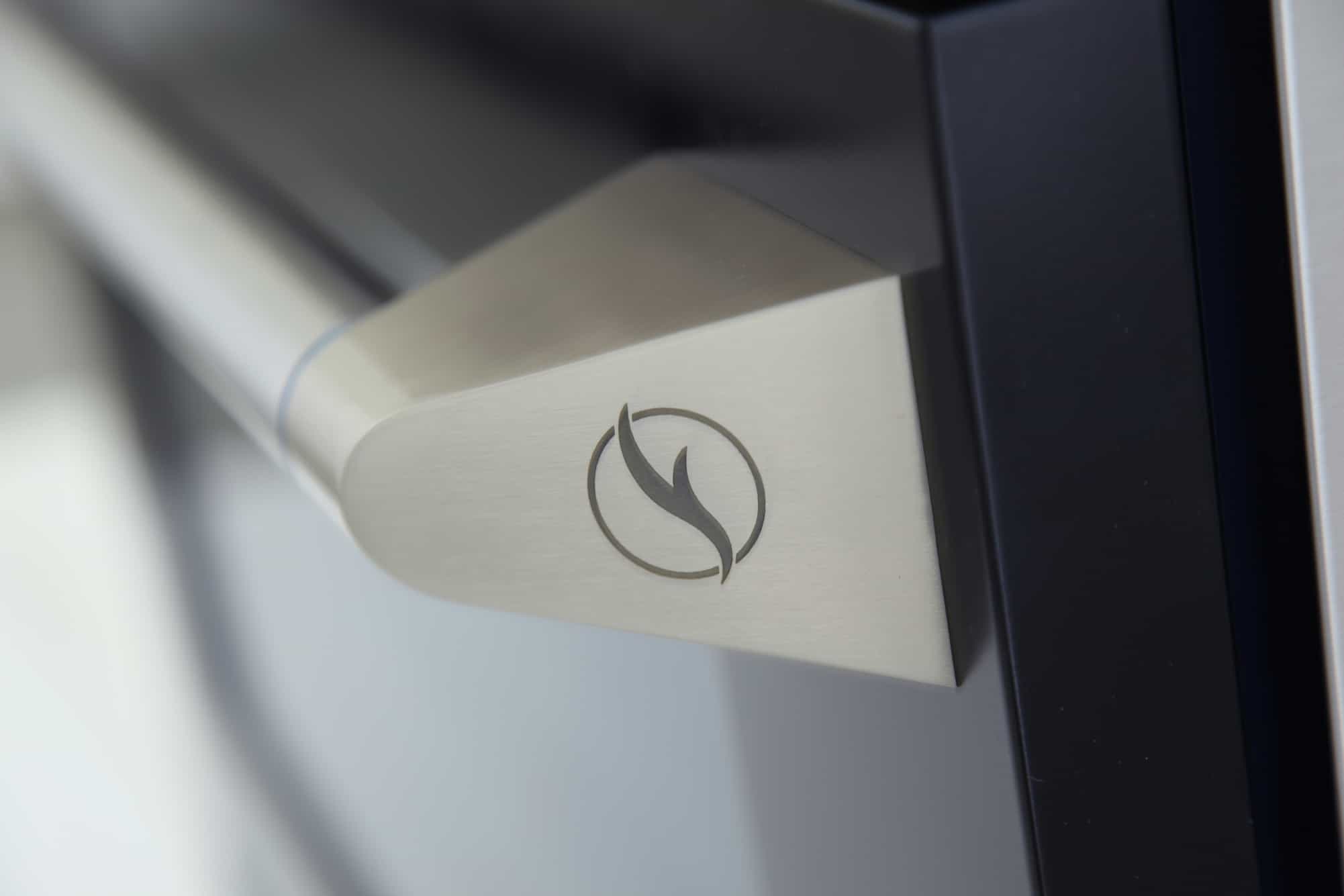 Stainless steel oven handle detail with Kucht swirl emblem