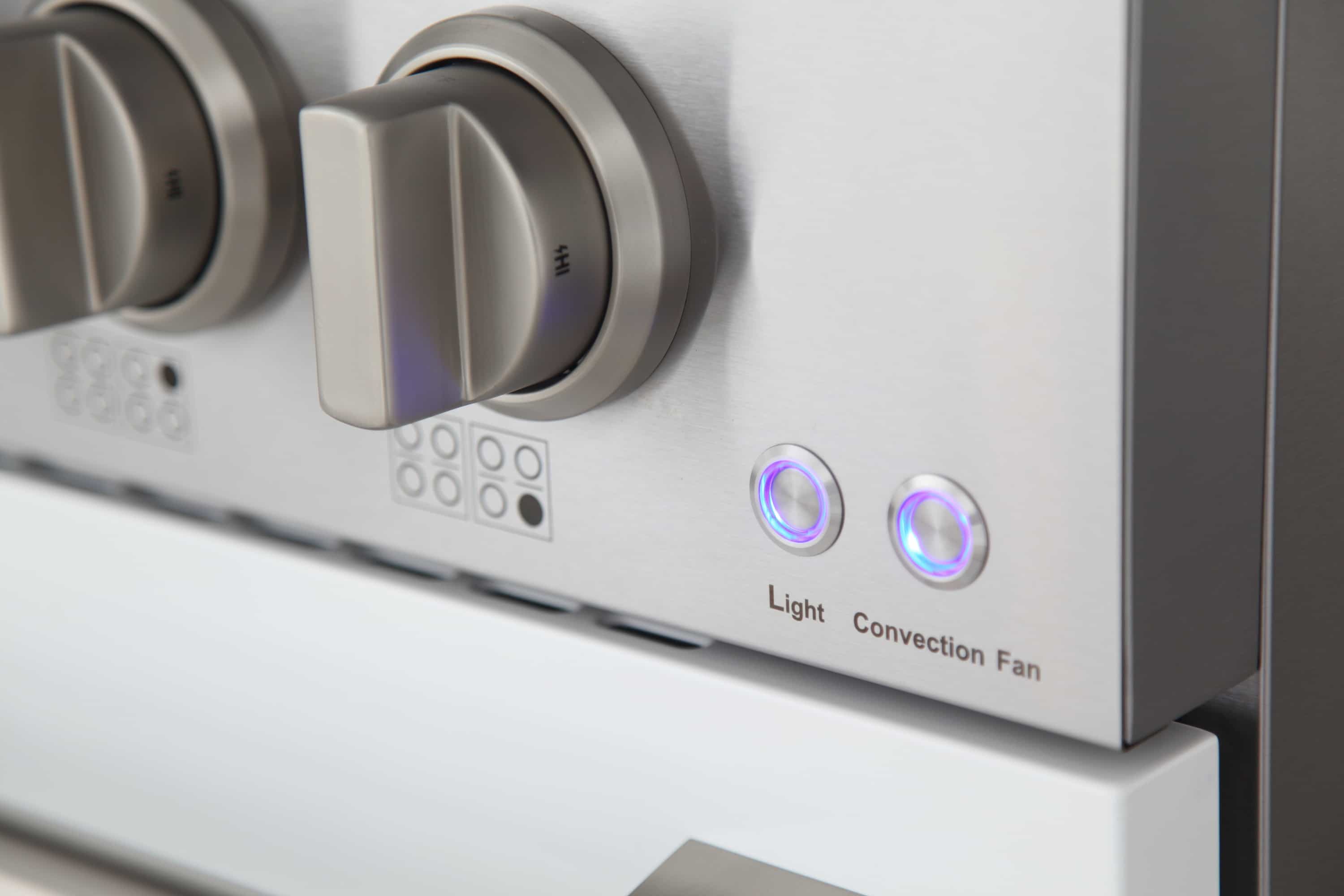 Range control panel with round knobs and blue “Light” and “Convection Fan” indicators